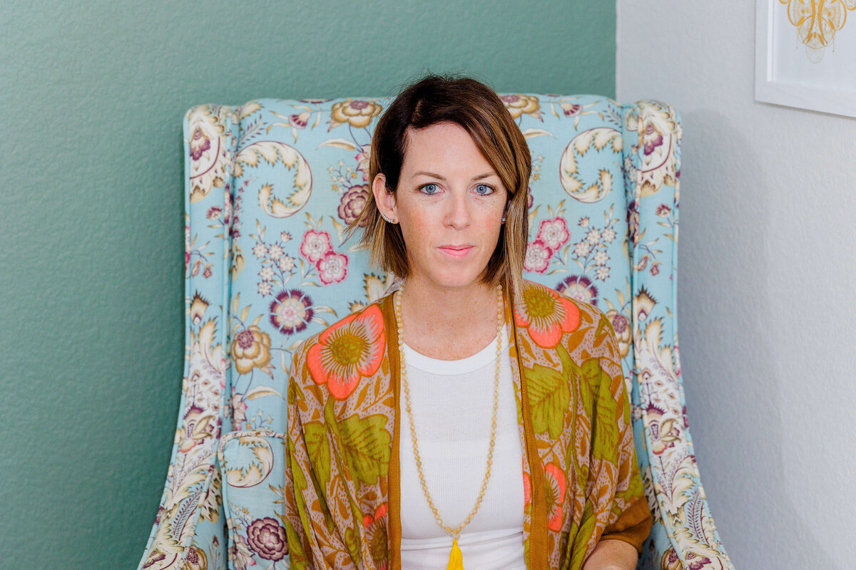 Headshot sitting on green chair