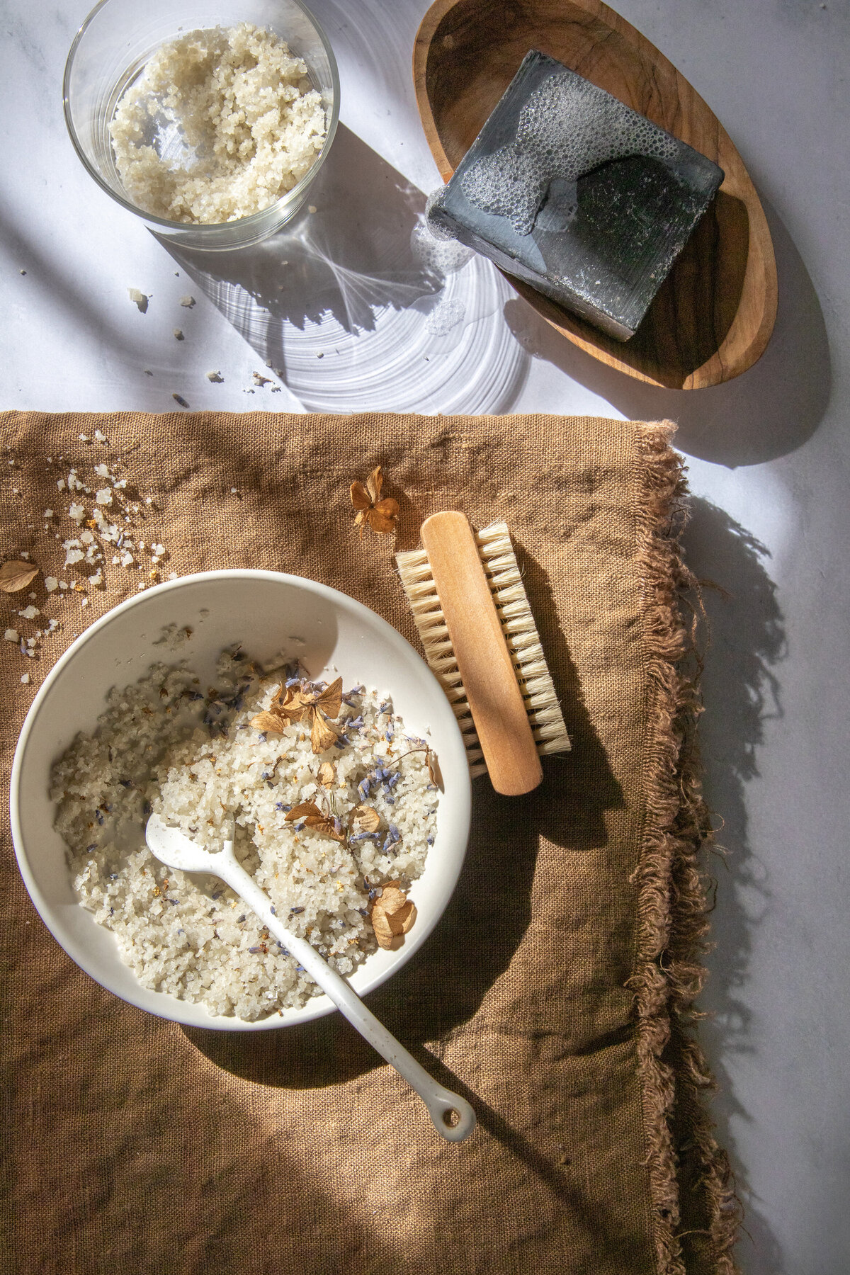 Natural light flat lay of bath salts and soap styled for eco wellness brand, captured by Richmond Virginia product photographer.
