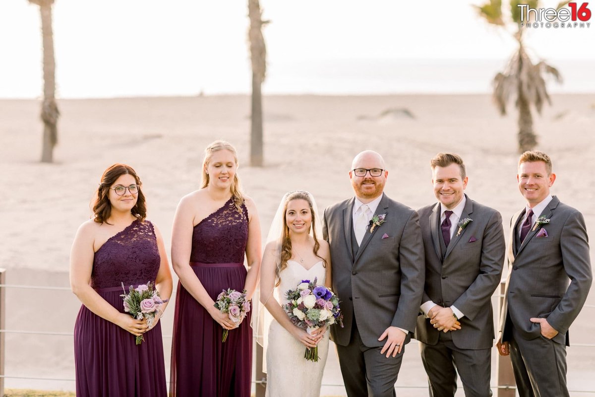 Bridal party posing at the beach