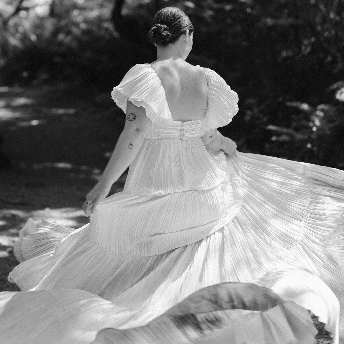 Bride in a chiffon gown, twirling in Cannon Beach, Oregon