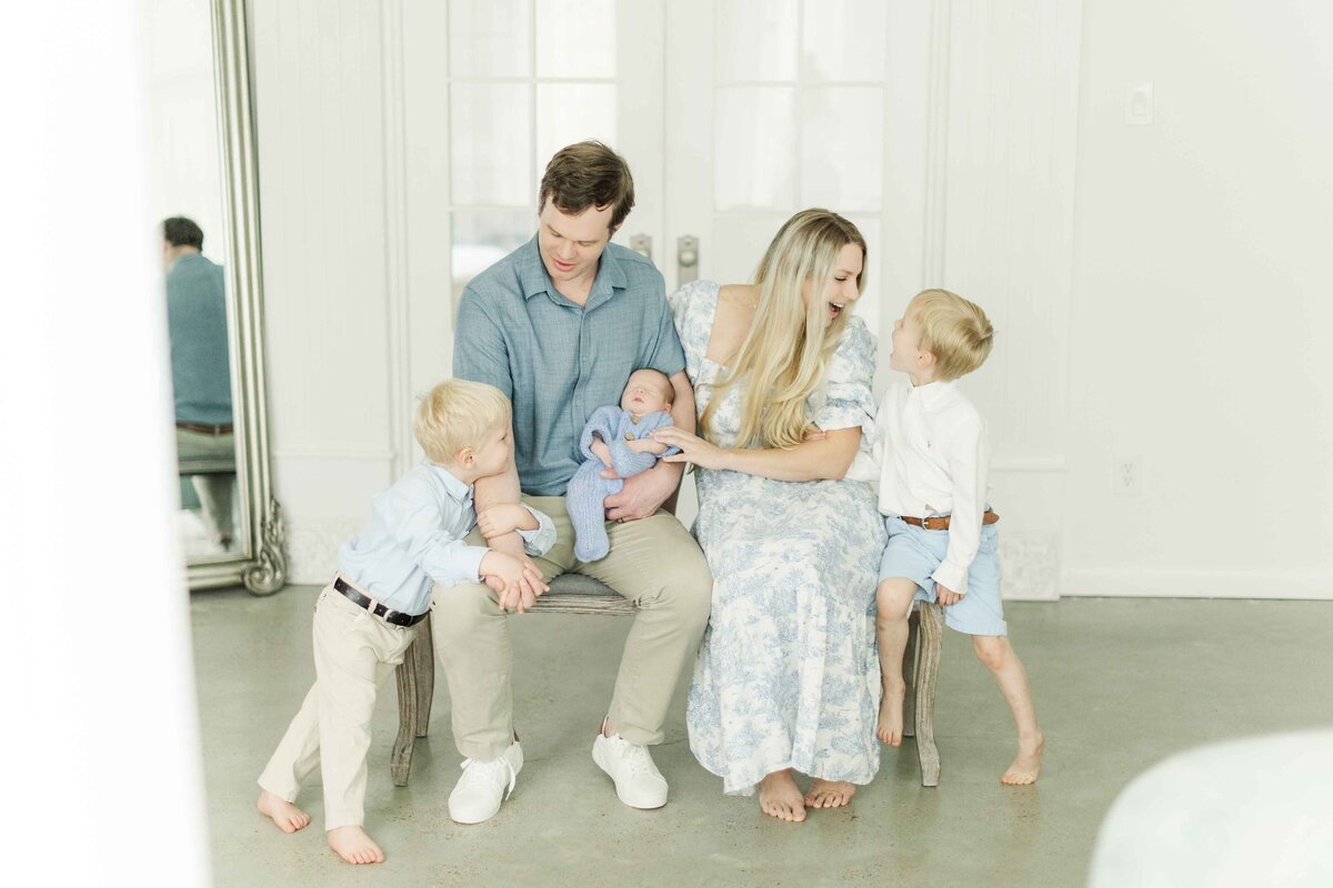 family of five play together in houston studio for newborn portraits