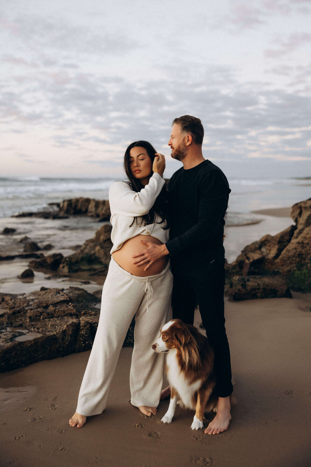 pregnant couple with their dog