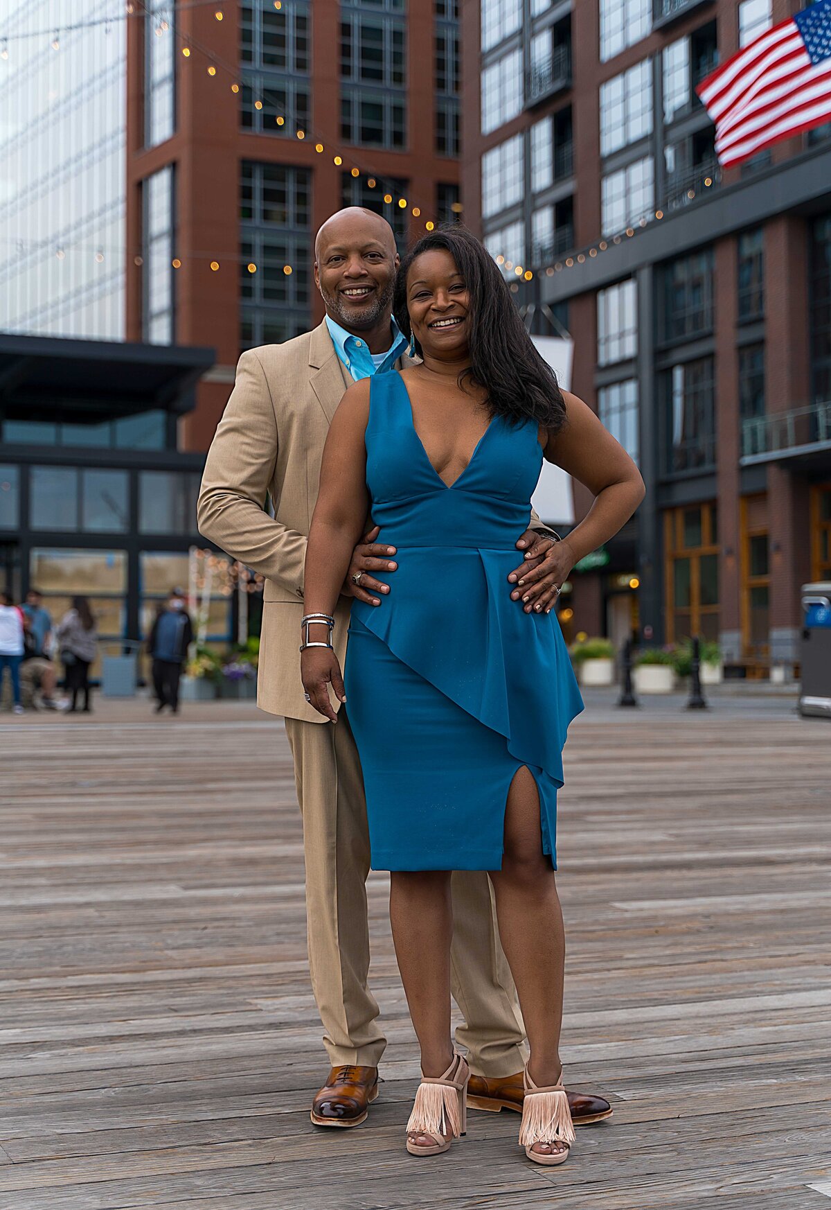 Couple stands and poses during engagement session at the Wharf in Washington DC