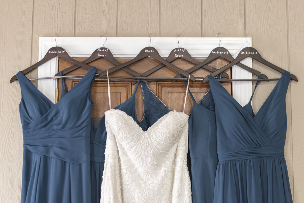 Wedding dress hanging with bridesmaid dresses