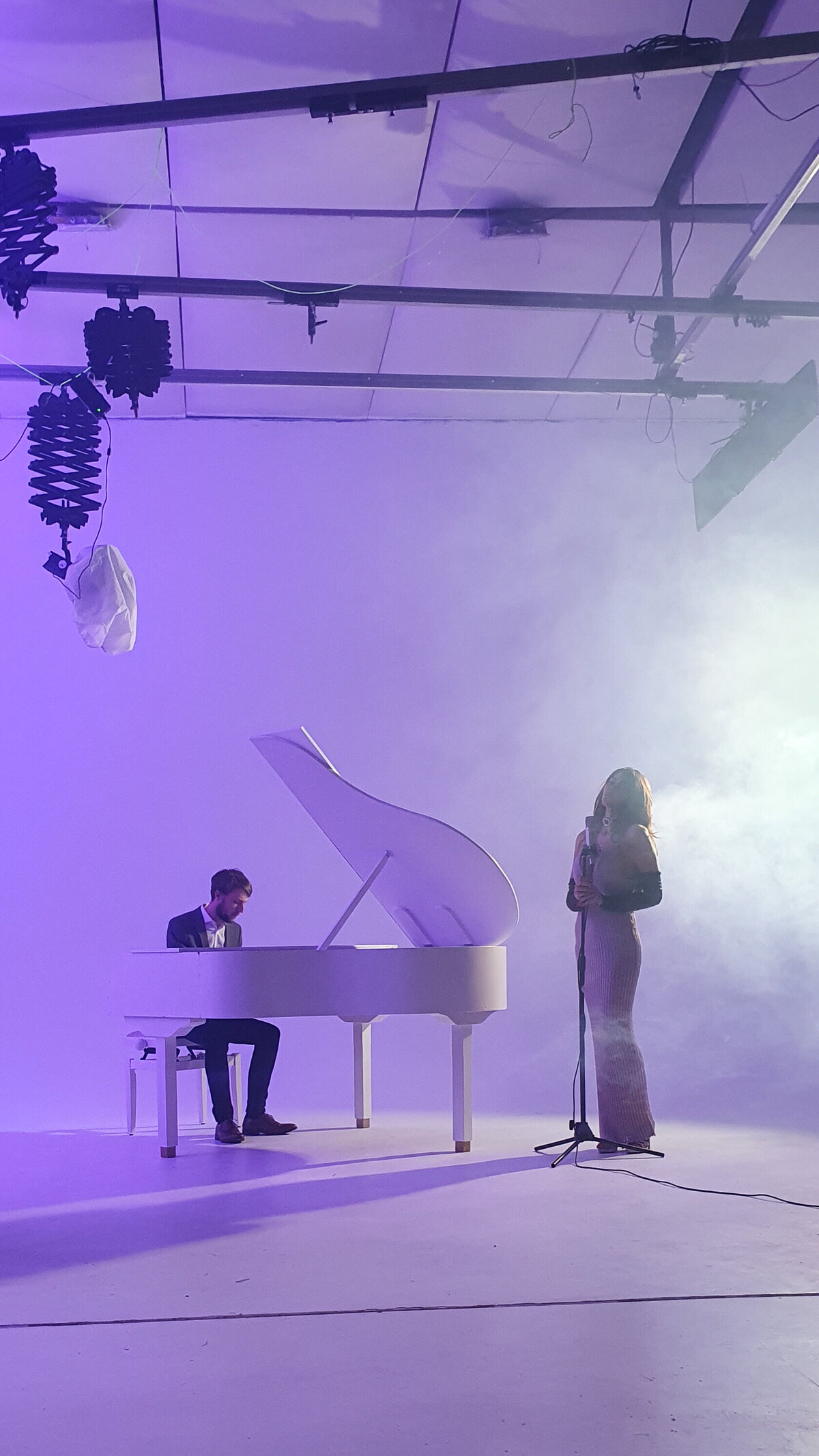white baby grand piano for video shoot