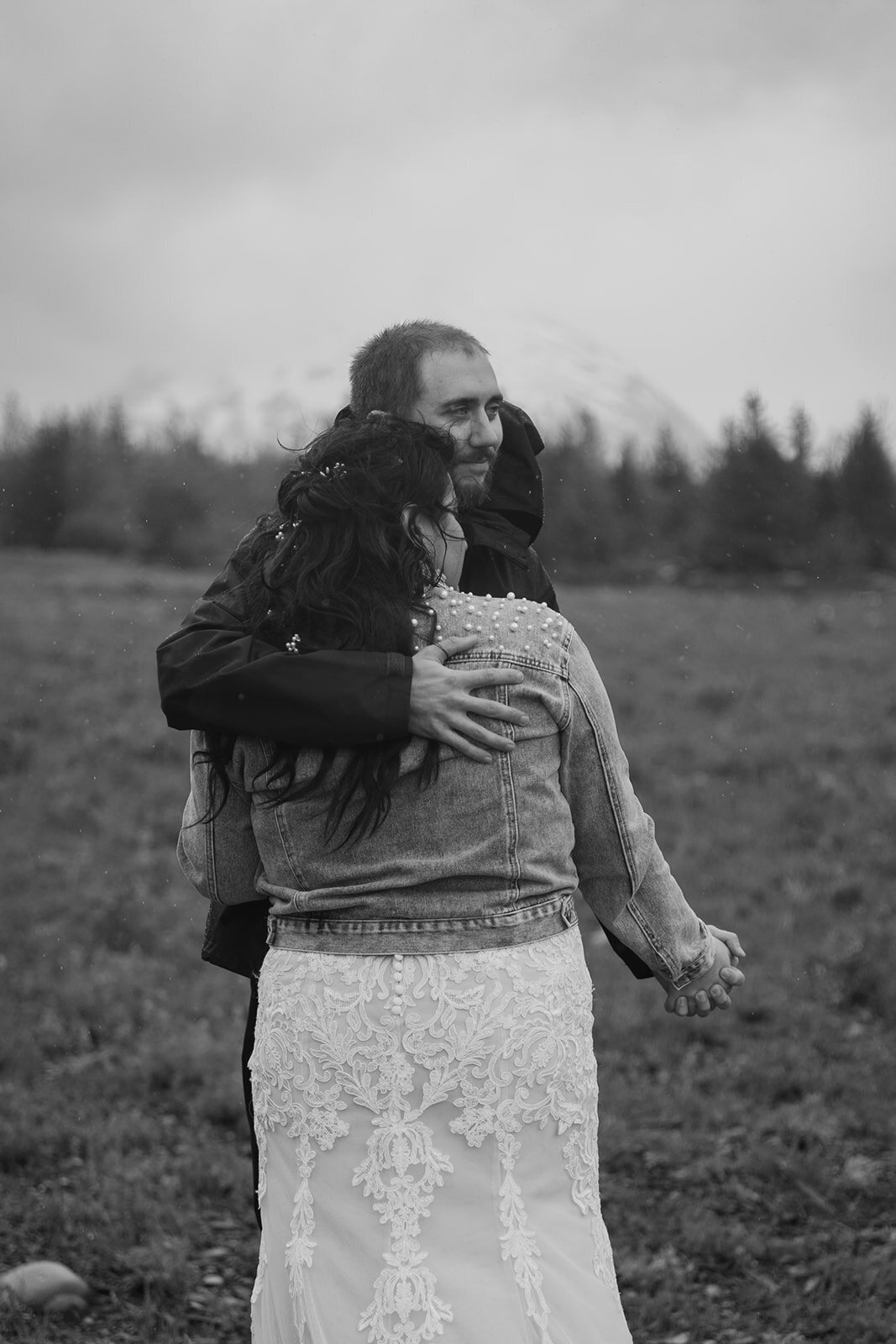 Black and white portrait of elopement couple dancing in the rain.