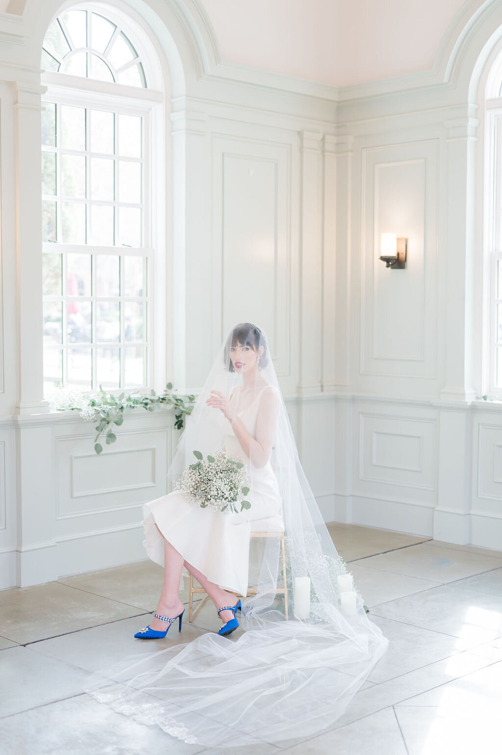 The mantilla-style Orchids Veil with its attached blusher and cathedral-length tulle add drama to any bridal portrait.