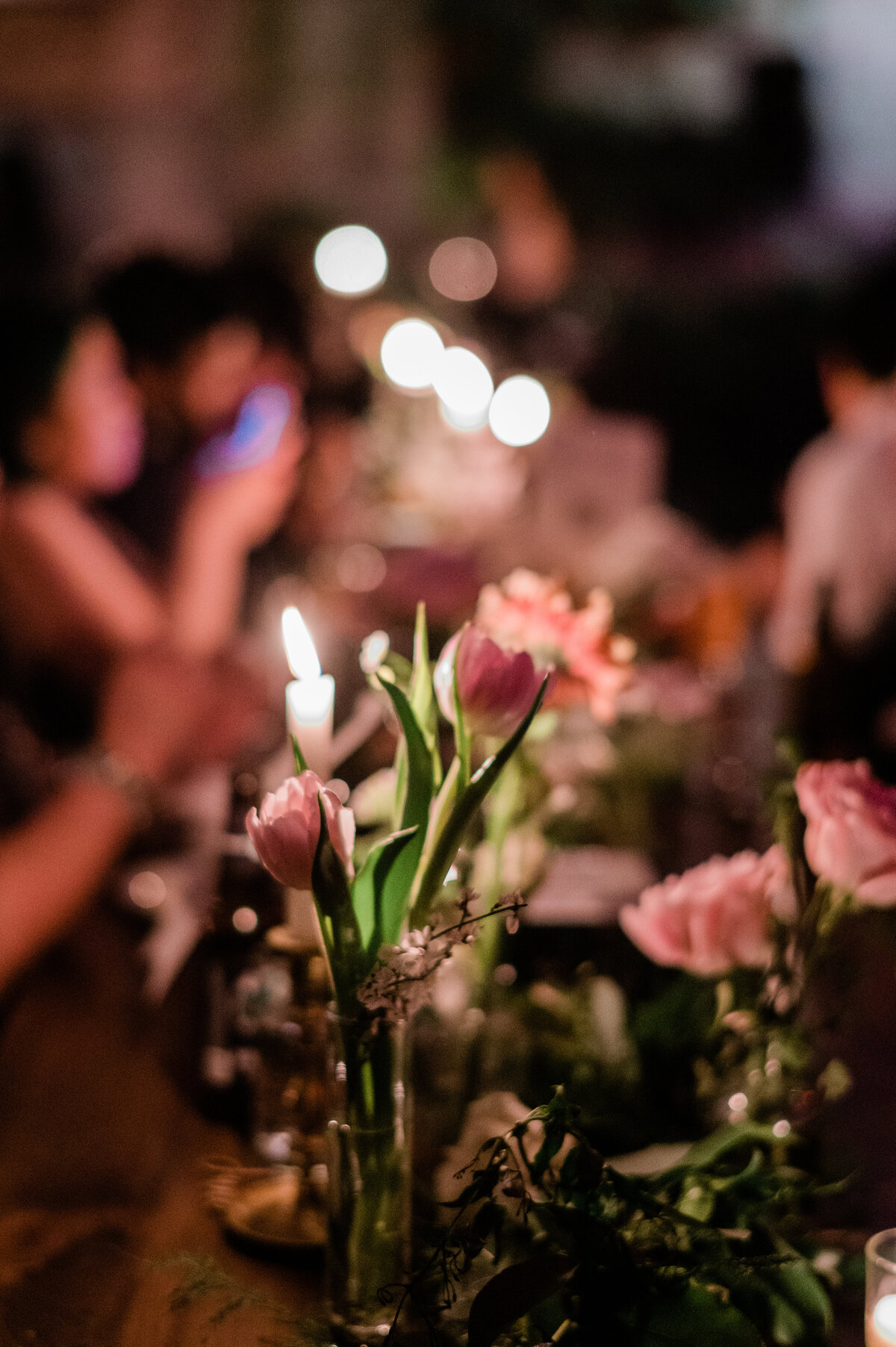 Two pink florals sit on the reception table