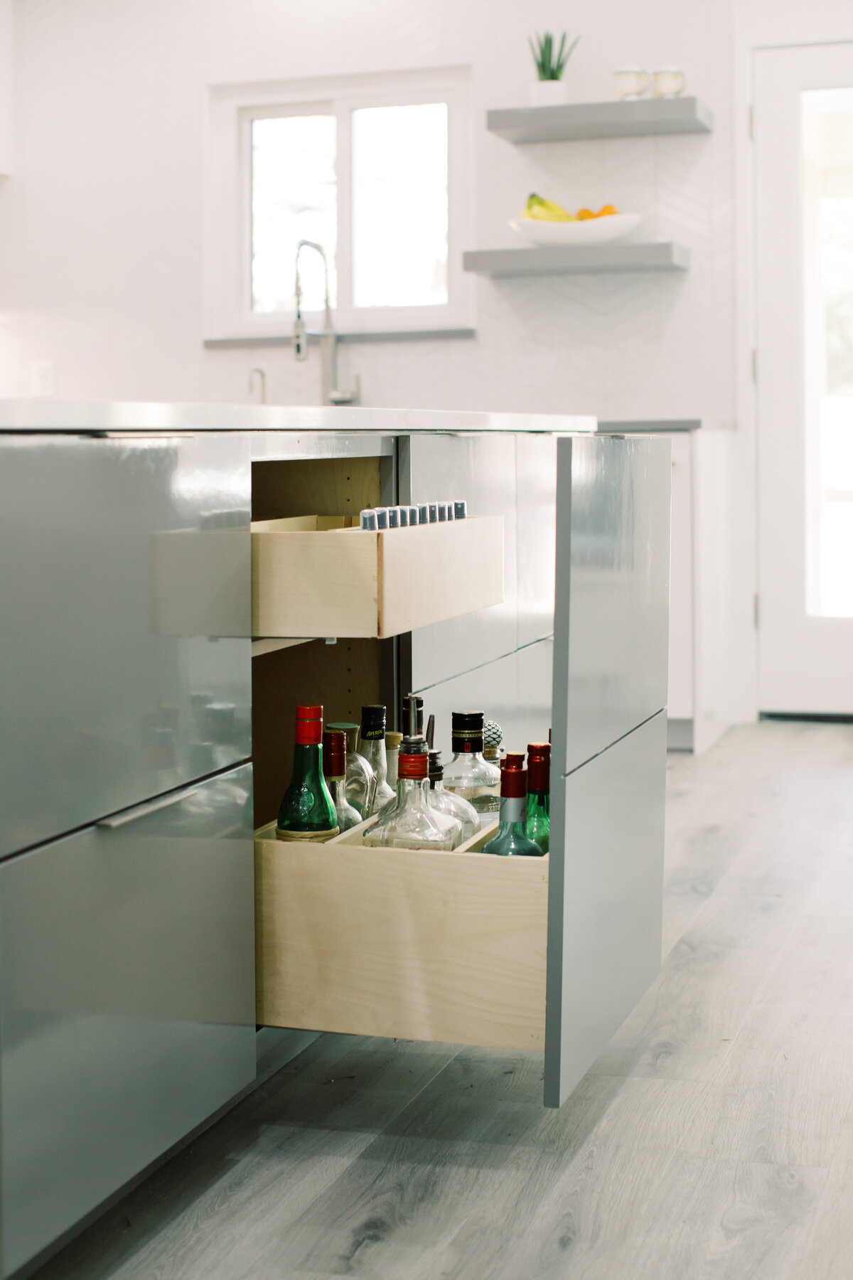 hello-home-sleek-modern-grey-and-white-kitchen-oversized-island-liquor-storage-austin-43