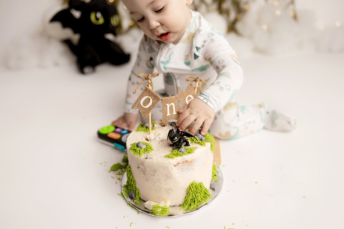Baby boy sitting with his smash cake in Colorado studio