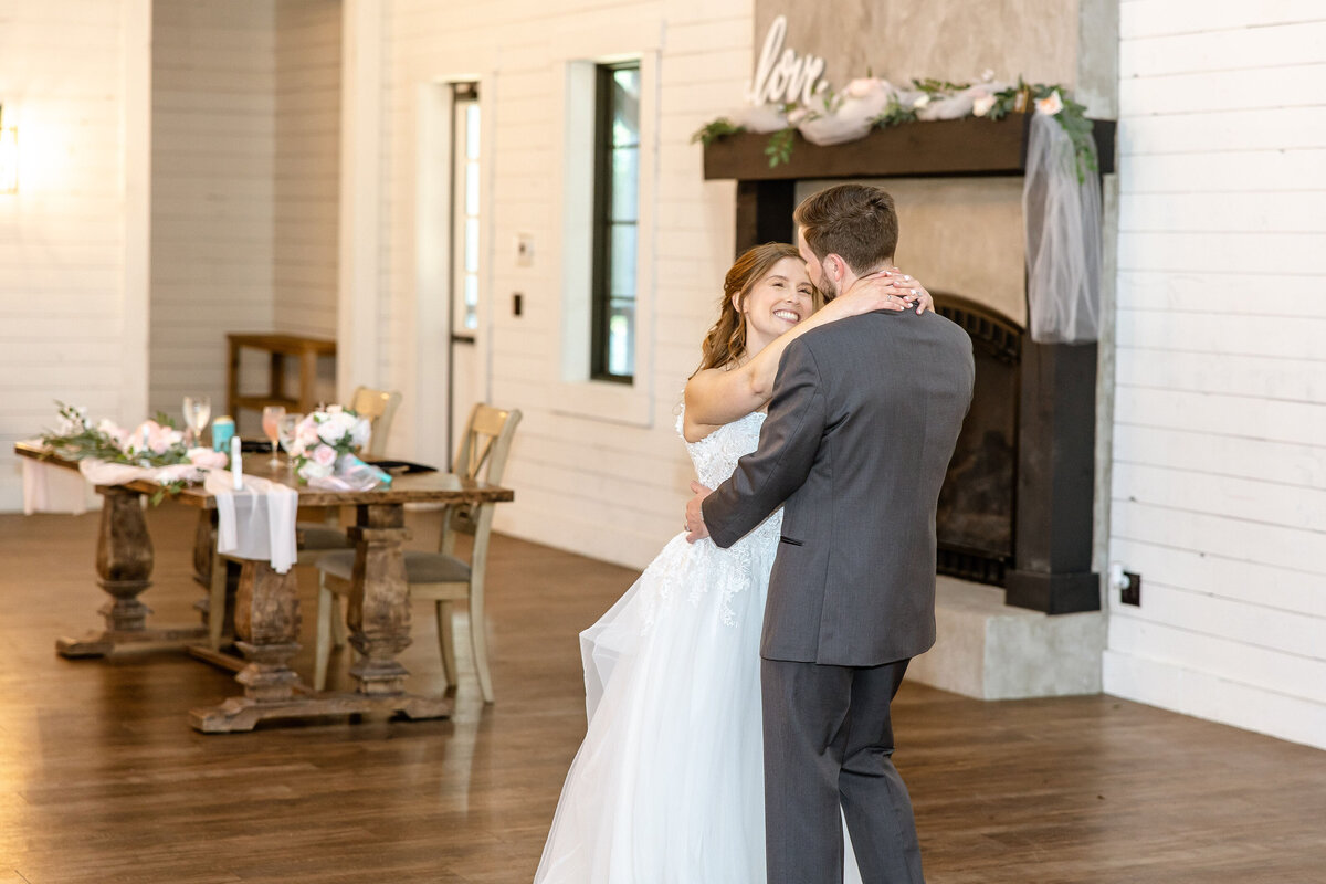 bride and groom dance by sweetheart table at Morgan Creek Barn wedding