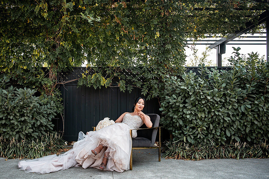 Romantic bridal portrait in champagne tulle gown among lush greenery at Estate Yountville, luxury wedding photography by San Francisco Bay Area photographer