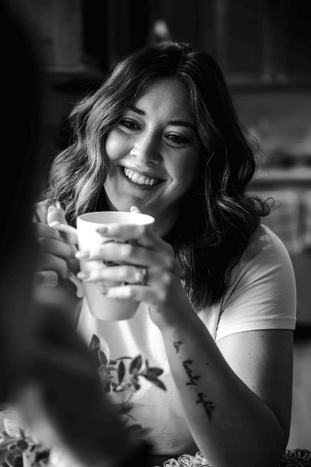 wife looking at husband over tea in black and white