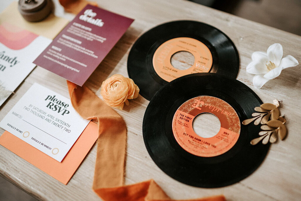 Retro inspired wedding decor featuring vintage vinyl records, orange and mauve invitation, styled by Melissa Alison Events, a wedding planner based in Calgary, Alberta.