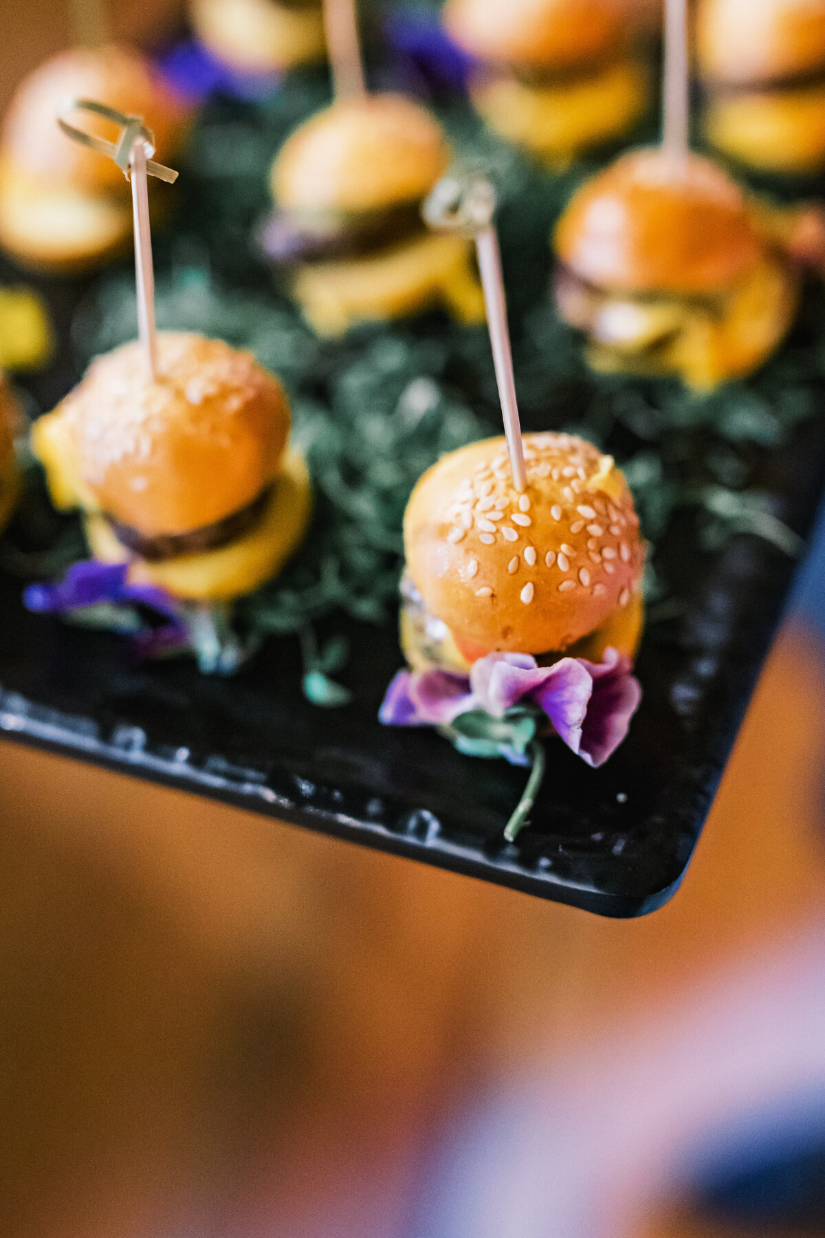 Mini slider appetizers garnished with edible flowers served during a wedding reception at Old Edwards Inn in Highlands, North Carolina.