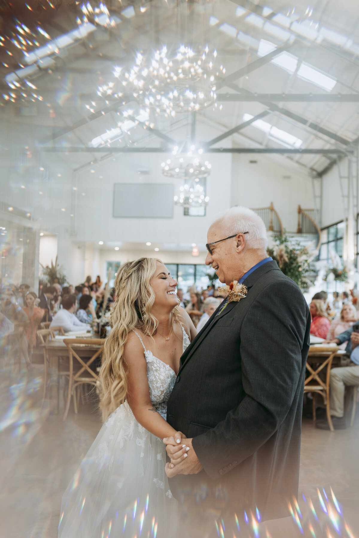 Bride dances with her father in front of audience at Bella Cavalli