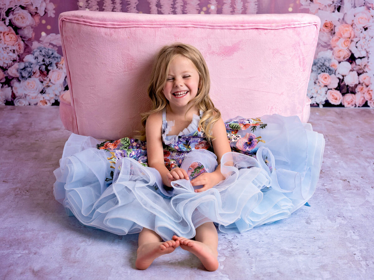 Young girl laughs in couture dream dress in Prescott kids photos by Melissa Byrne