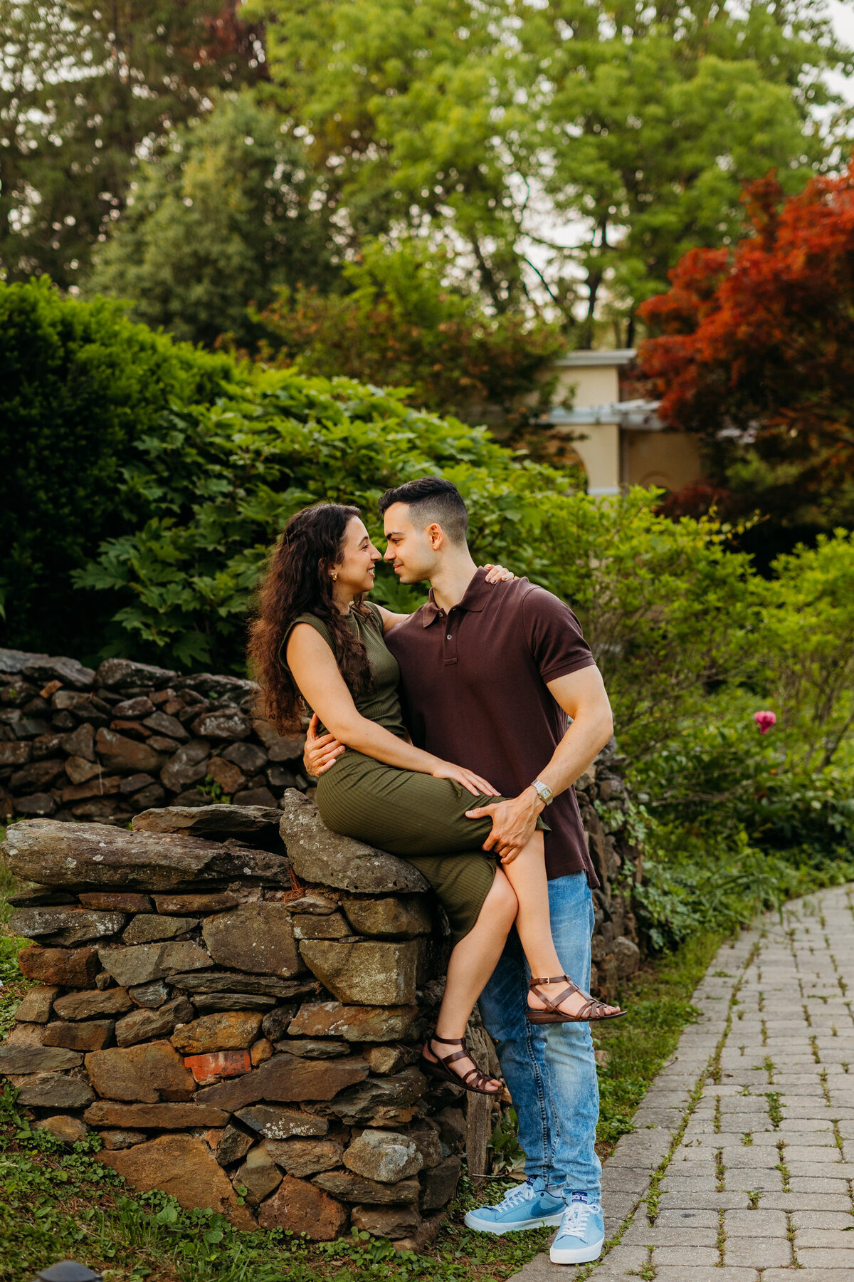  Romantic kiss on stone steps surrounded by greenery