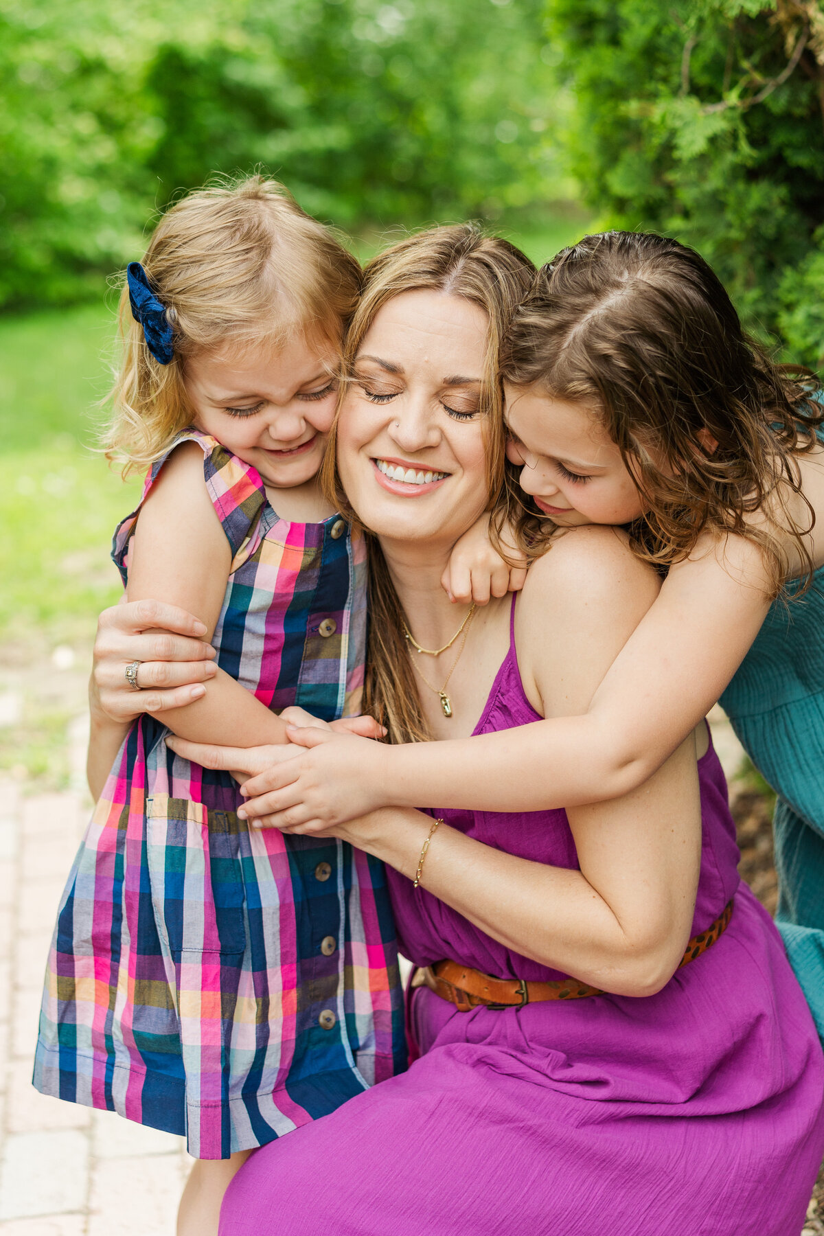 A mother embraces her children