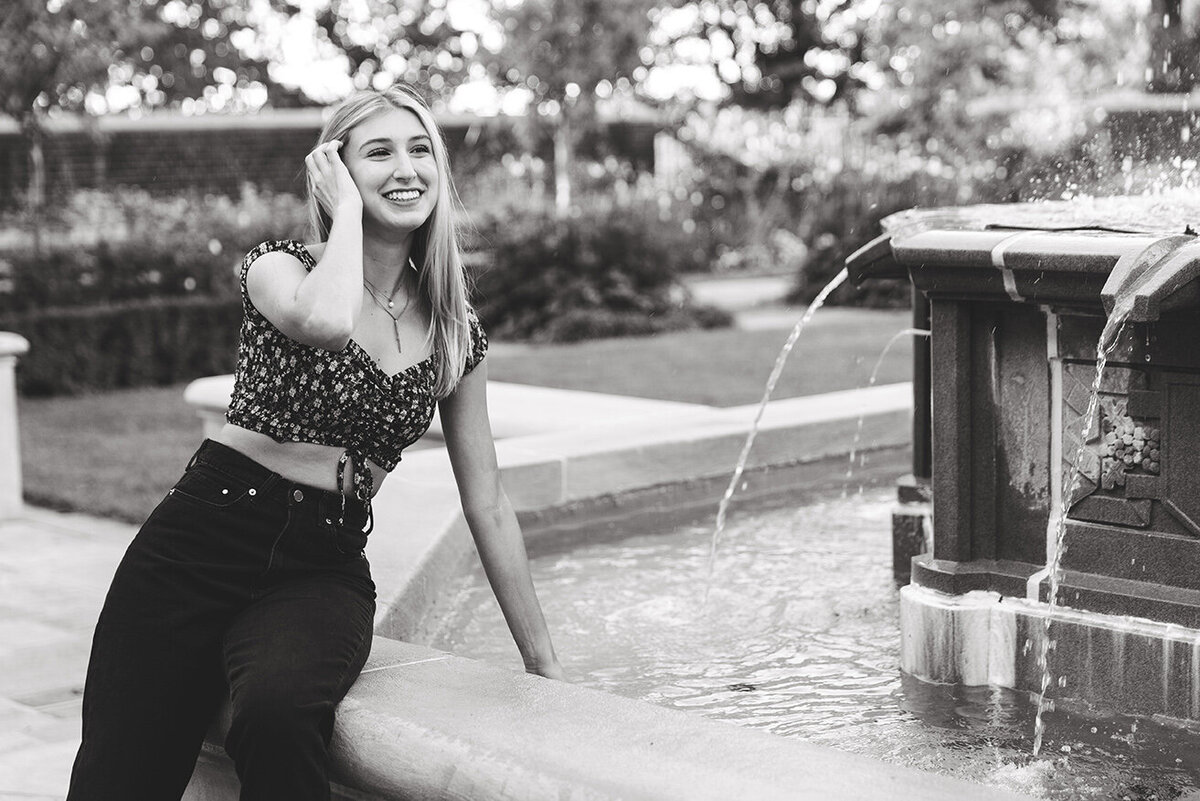 girl splashing in fountain
