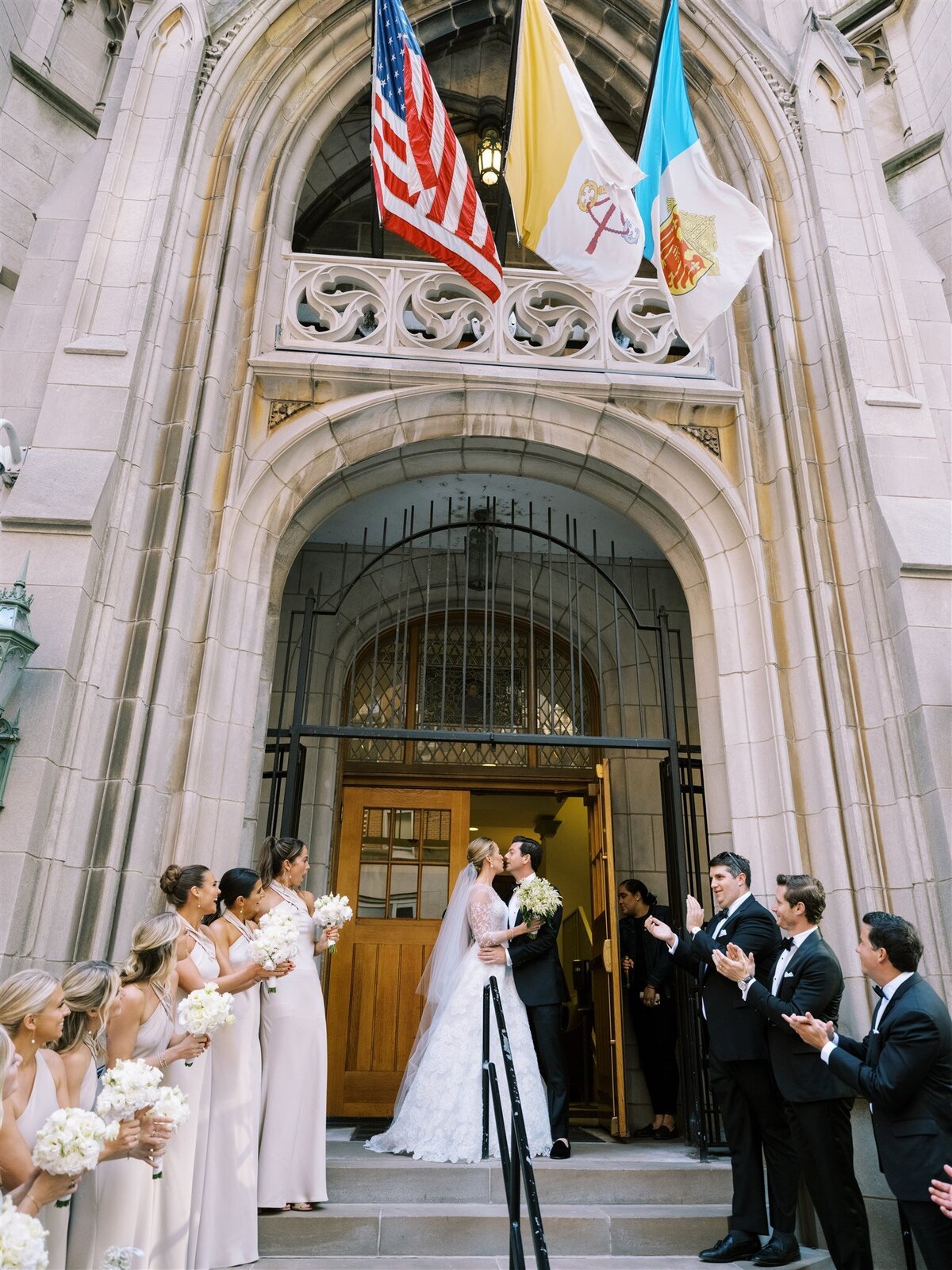 The bride and groom about to share a kiss outside the church in Chicago.