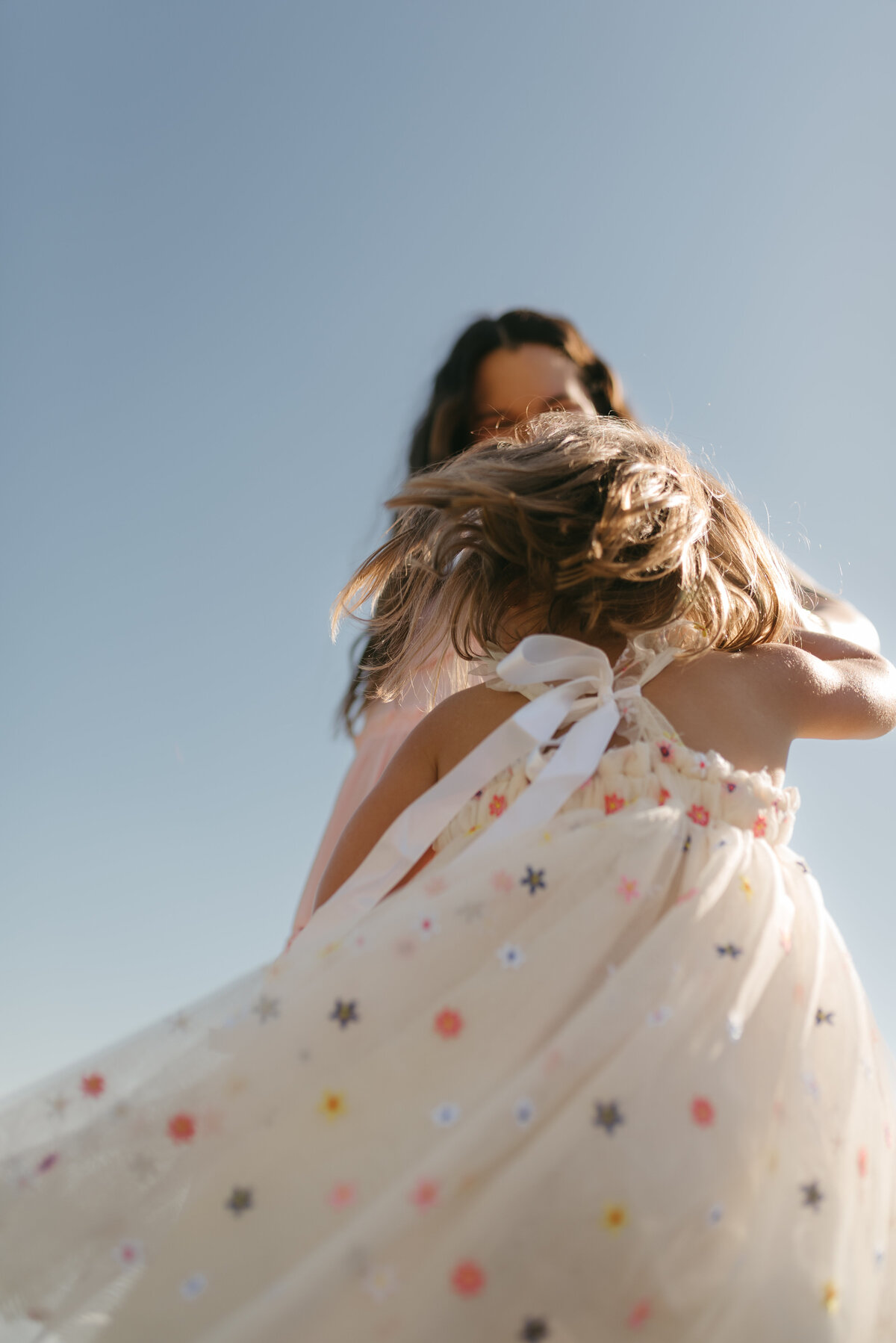 a mama twirling around her little girl