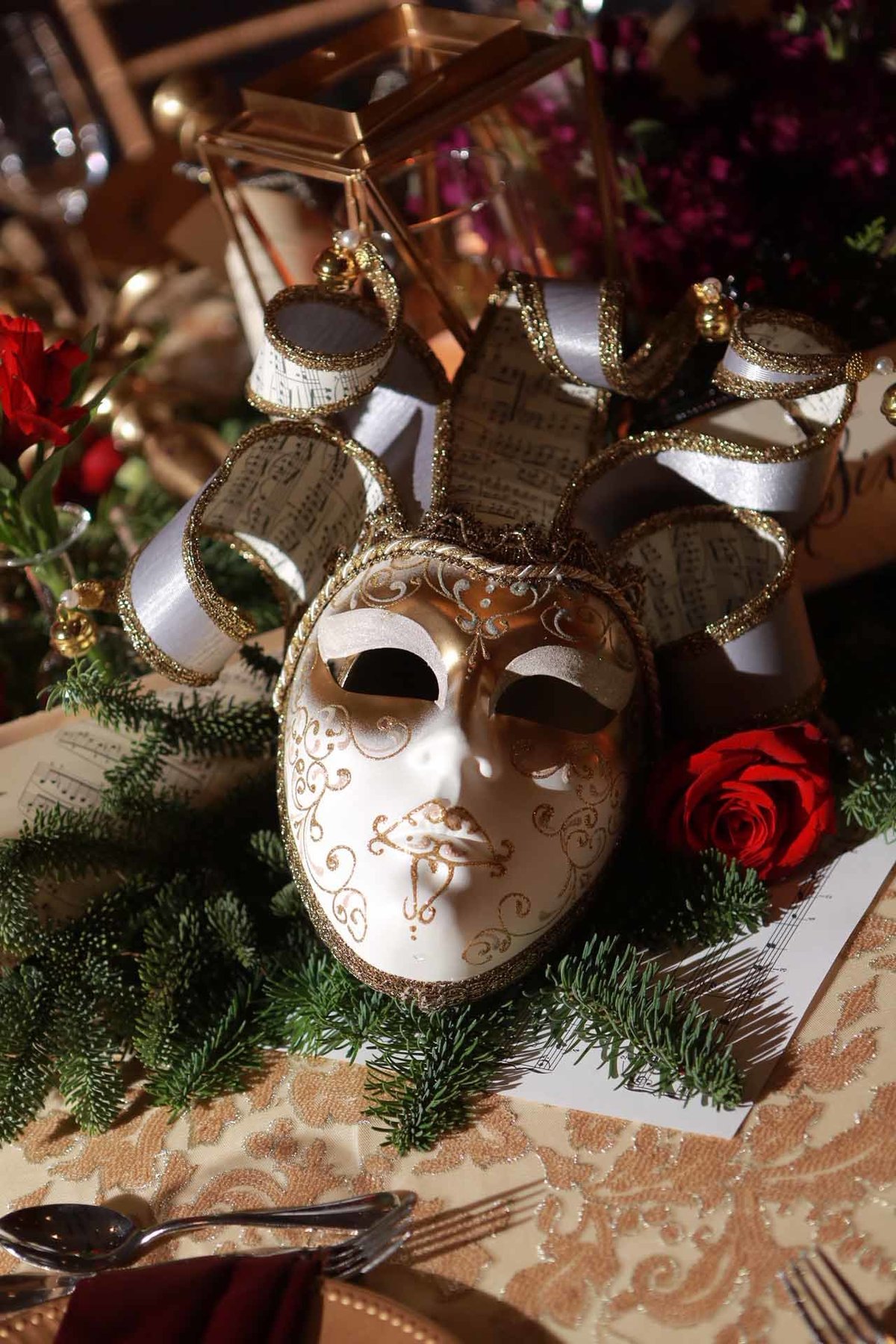 vintage carnival mask on evergreen runner as holiday centerpiece