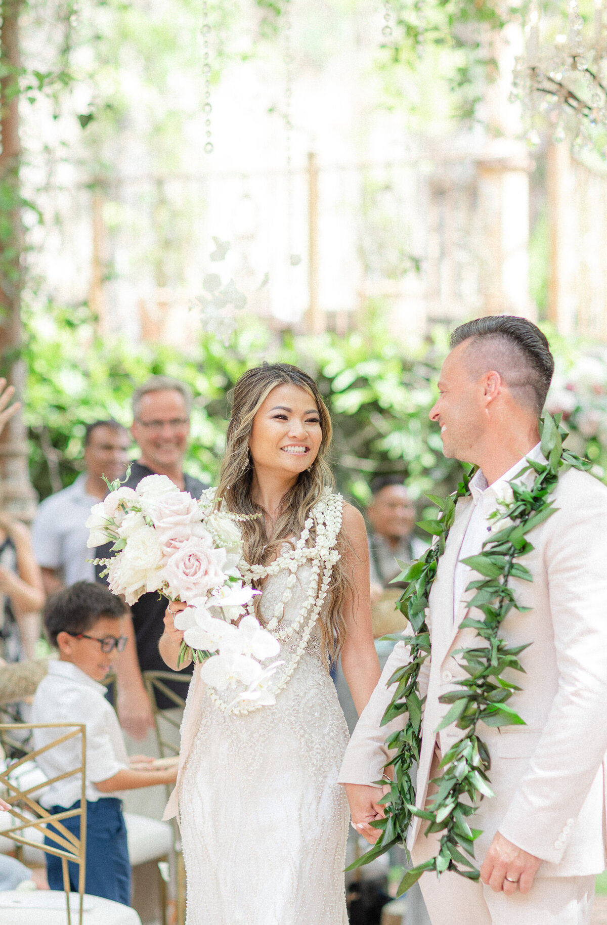 bride and groom walking down wedding aisle