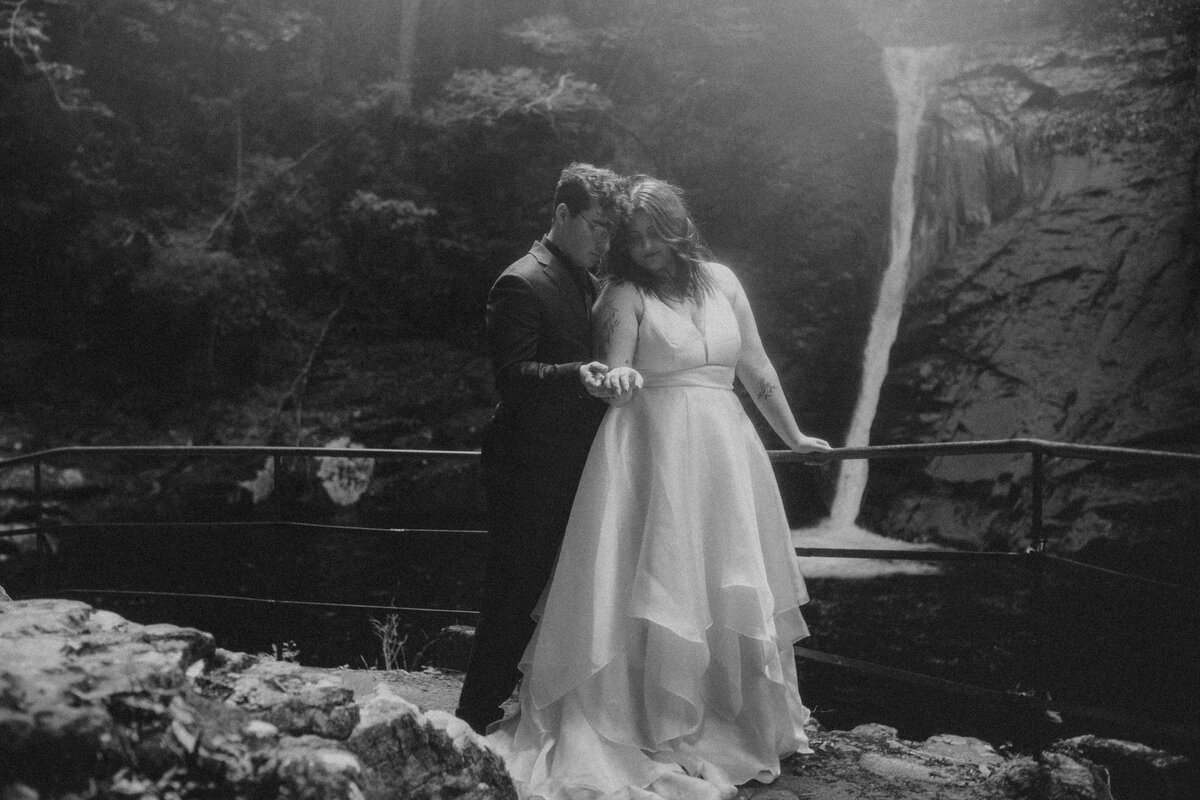 blurry black n white image of N & M walking away into the trees