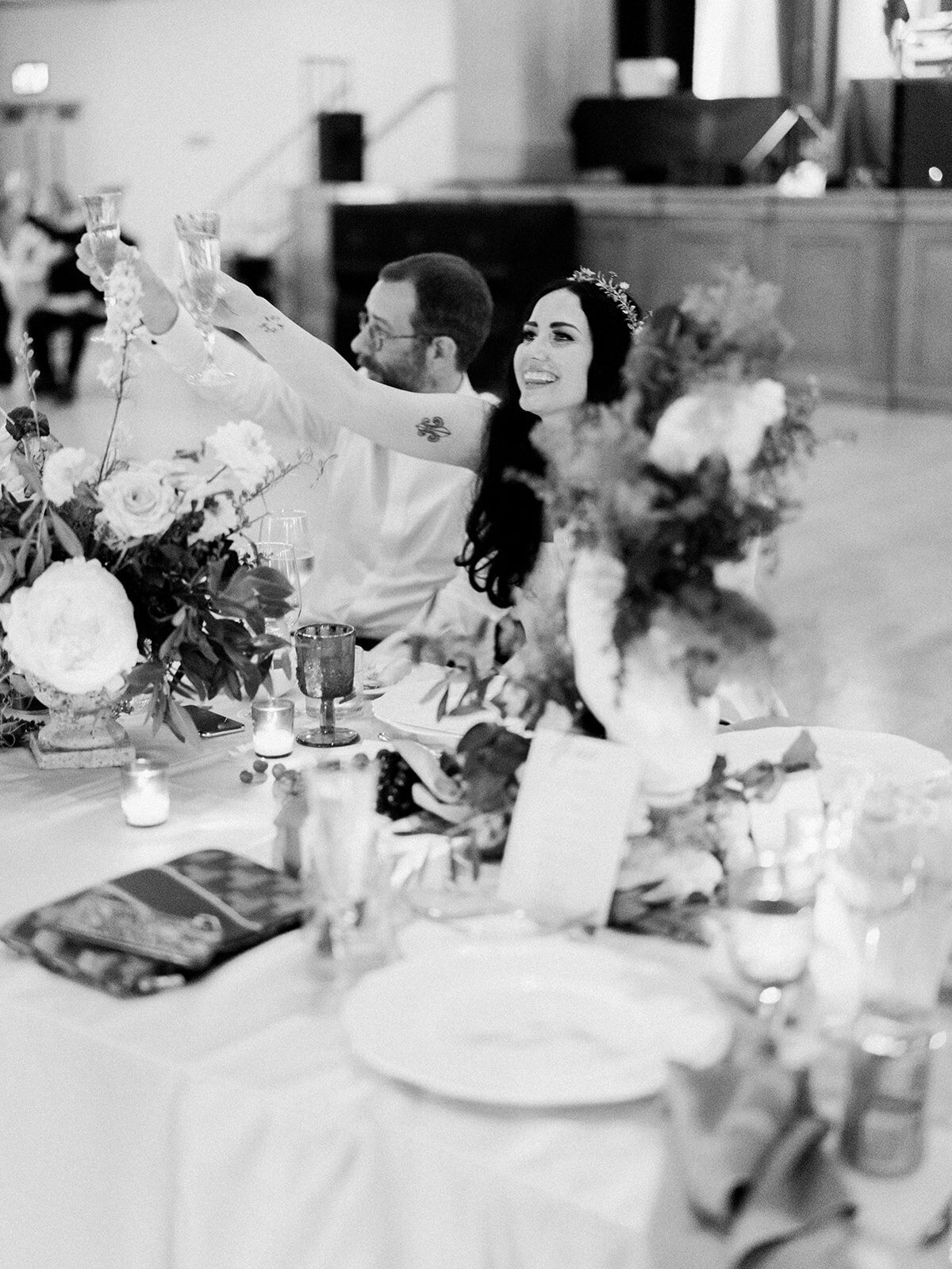 Beautiful reception adorned with marble busts covered in florals and lush centerpieces. The summer solstice color palette was filled with garden roses, peonies, ranunculus, pepper berry and fresh fruit. Design by Rosemary and Finch in Nashville, TN.