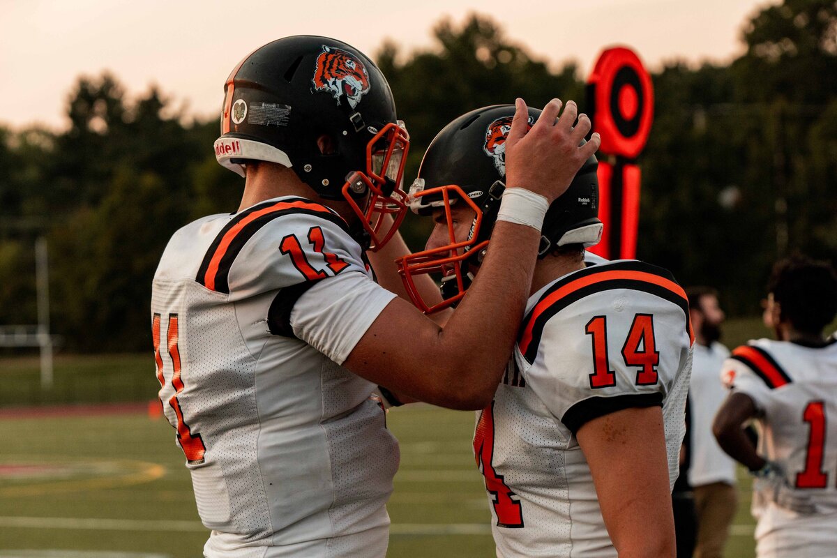 quarterback with teammate during game