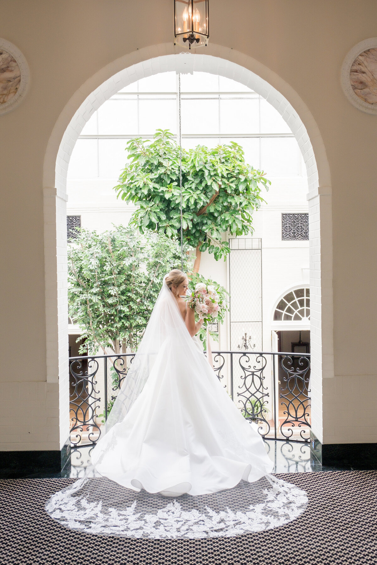 bride posing for wedding picture on the balcony of fox chapel golf club