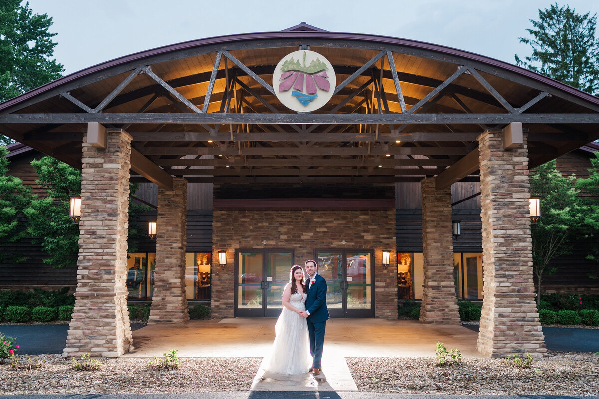 bride and groom posing for evening wedding photo outside of vineyards at pine lake event center
