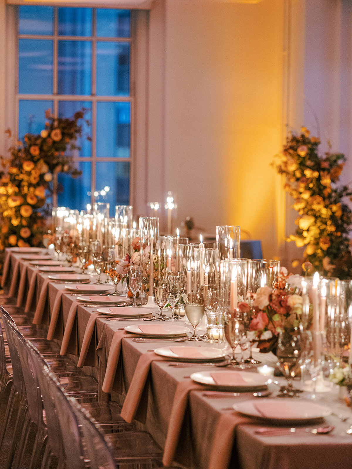 Indoor wedding tablescape design in NYC loft with candles and flowers