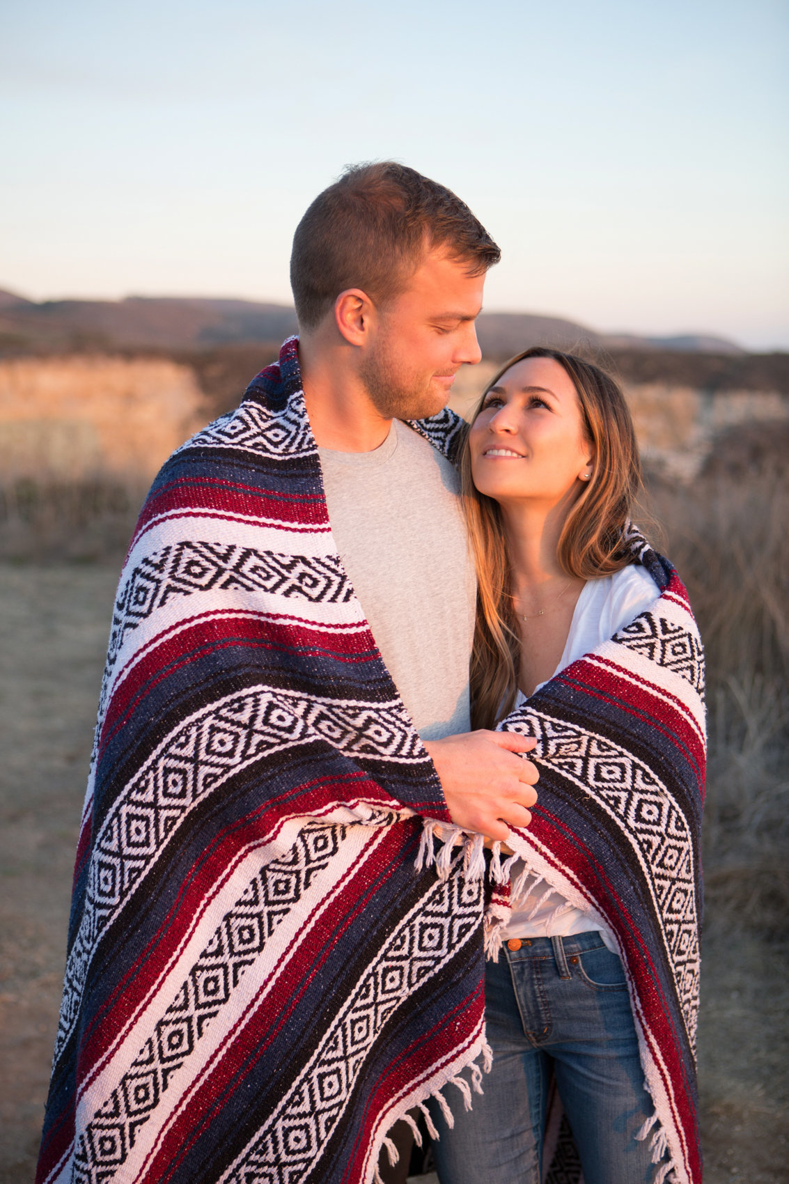 Bride and groom in blanket, natural light portrait in evening, northern california photoshoot with deneffe studios