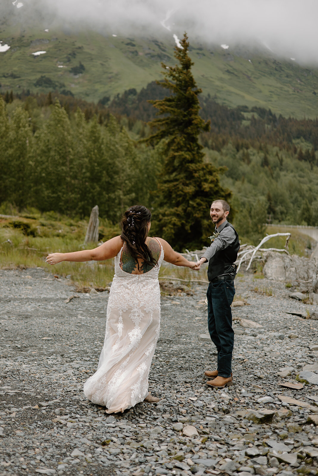 Elopement couple dances on Alaska shoreline.
