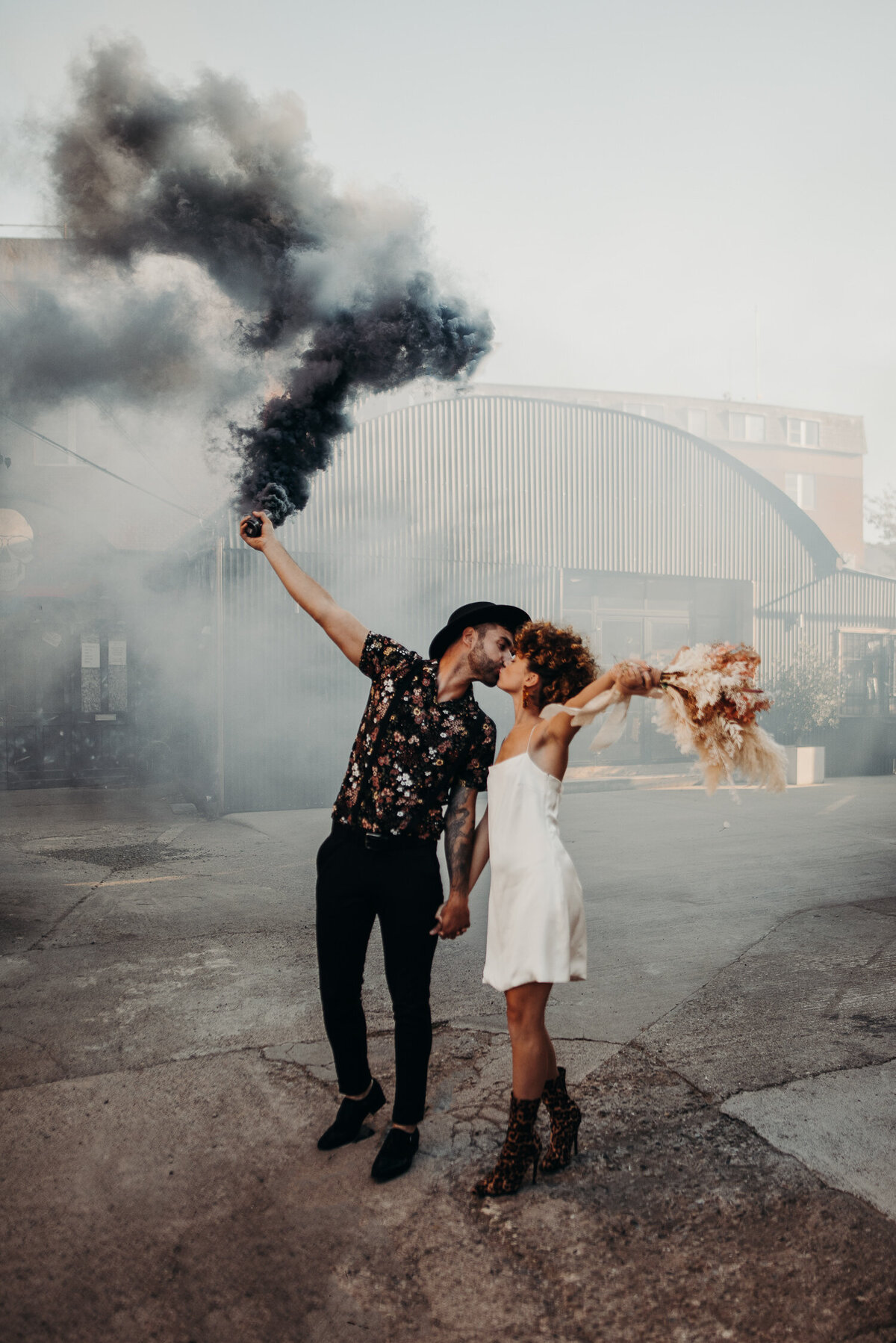 A couple light a smoke grenade of The Shack Revolution on their weddings day.