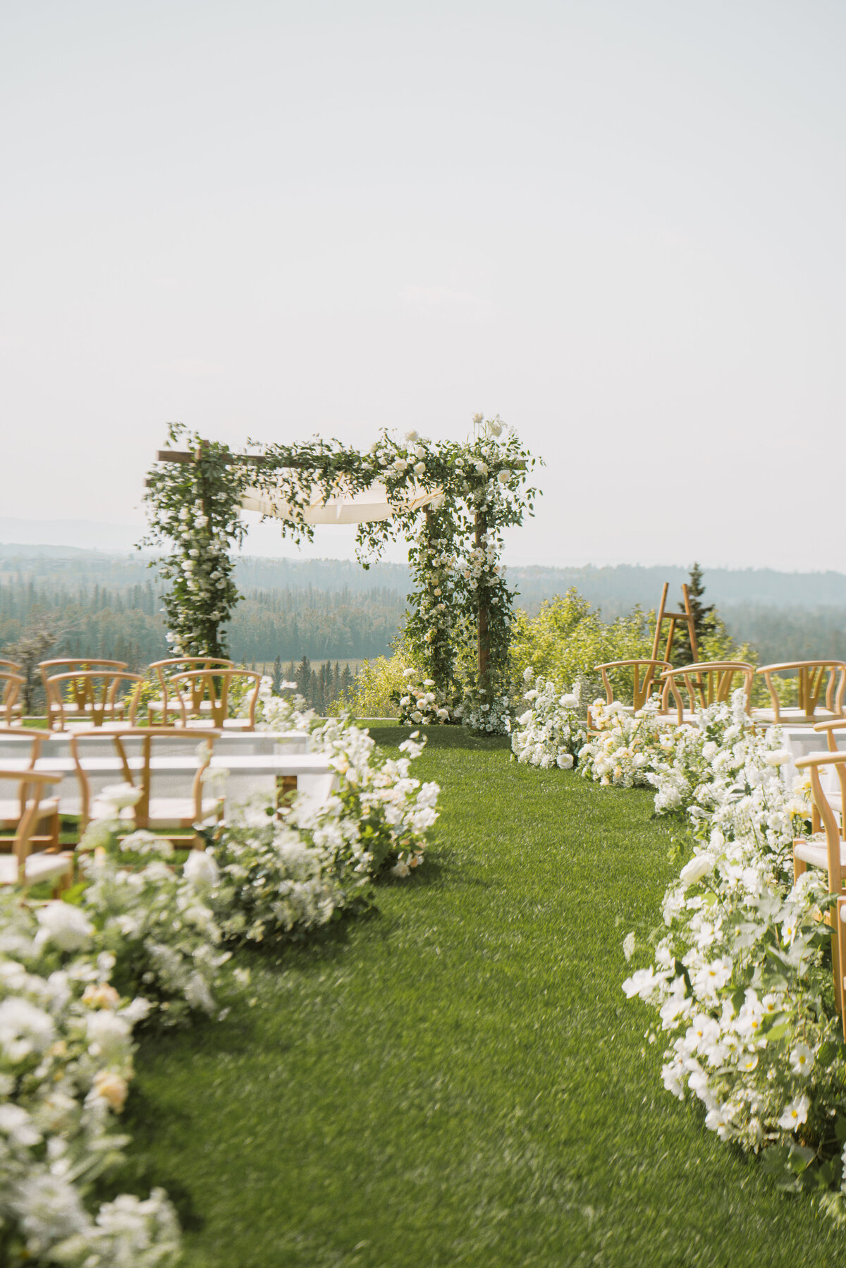 Summer wedding Ceremony at Pinebrook Golf Club, meadow aisle florals and luxury design aesthetic