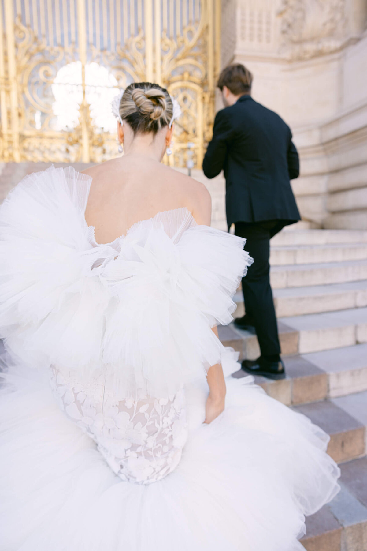 A wedding photo of a bride in her white dress in the streets of Paris in France.