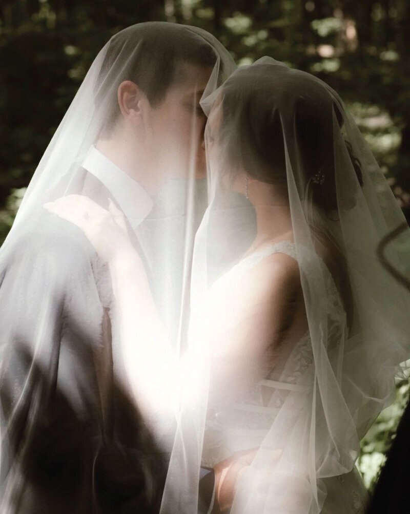 bride-kissing-groom-under-veil