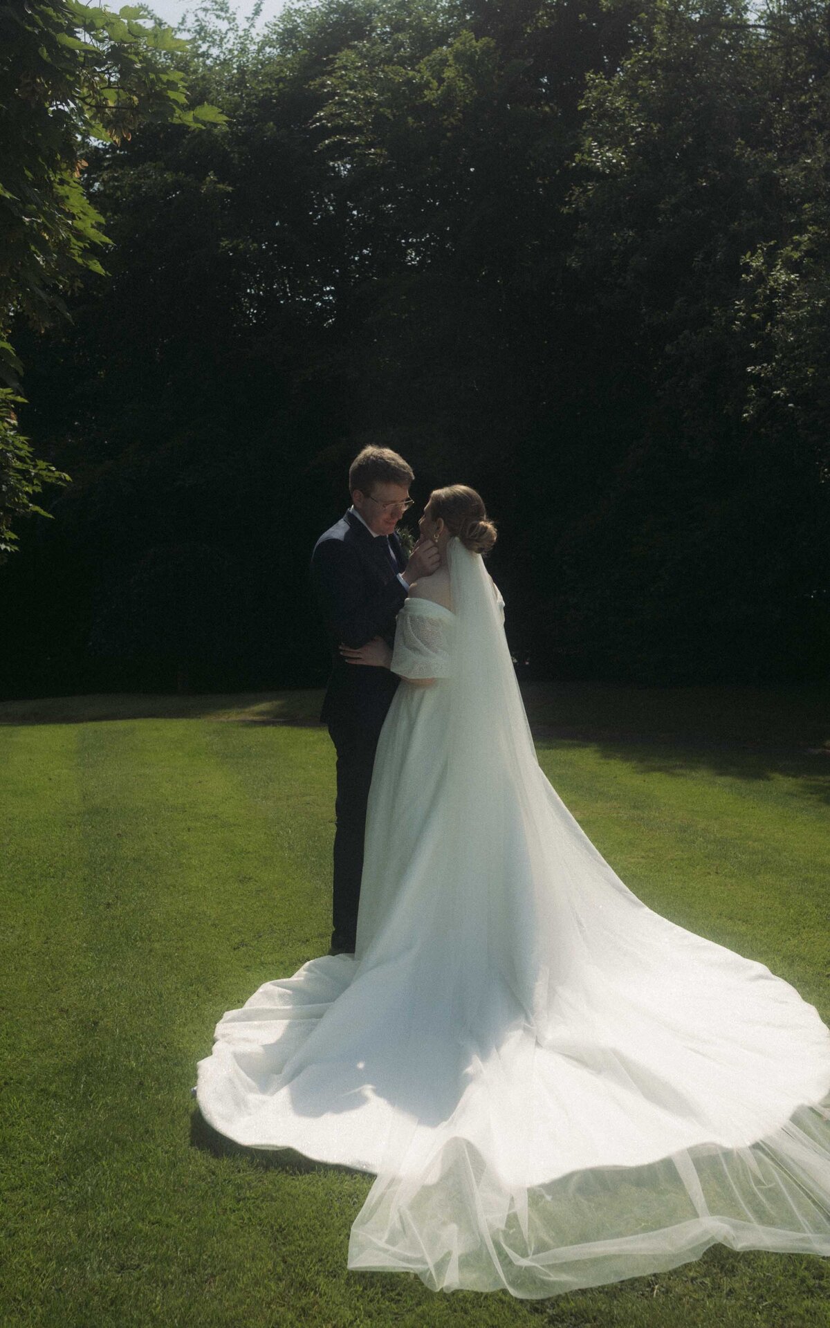 Capture the essence of love and connection with a married couple posing in a serene grass setting. This romantic and natural photoshoot showcases their bond against a peaceful outdoor backdrop
