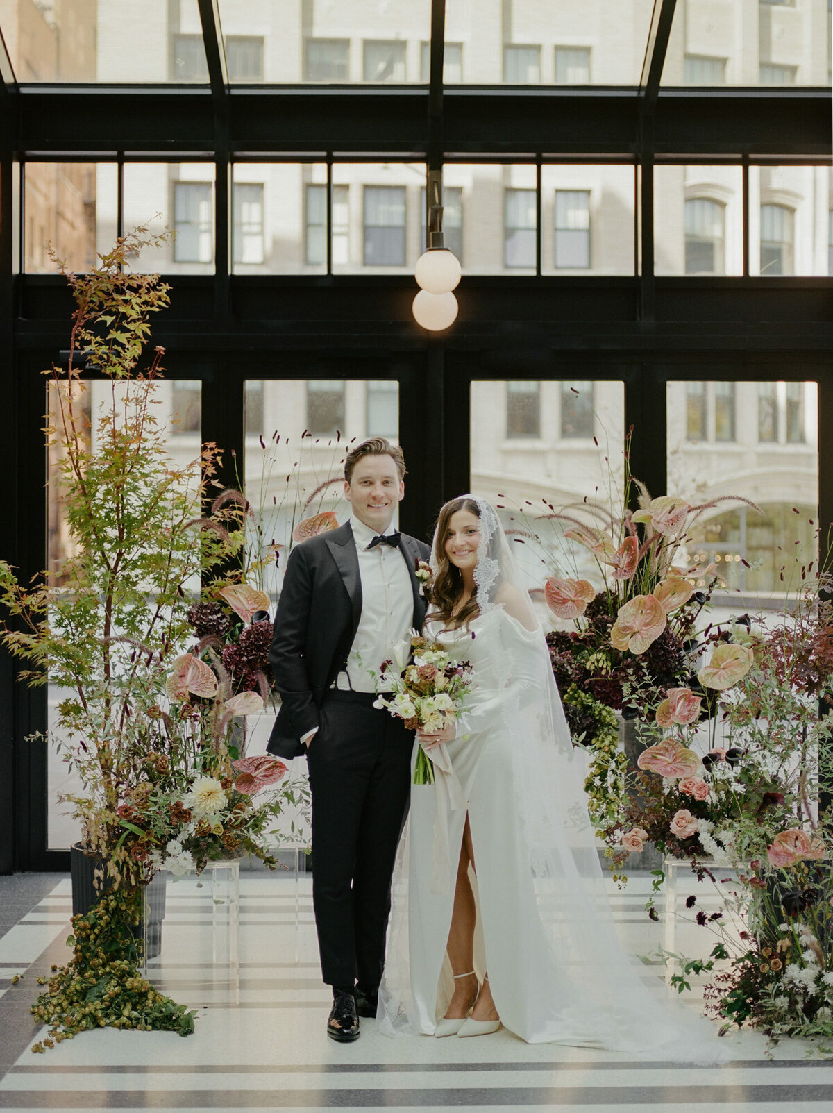 fall wedding flowers, couple stands in front of ceremony install Birdy room Shinola hotel