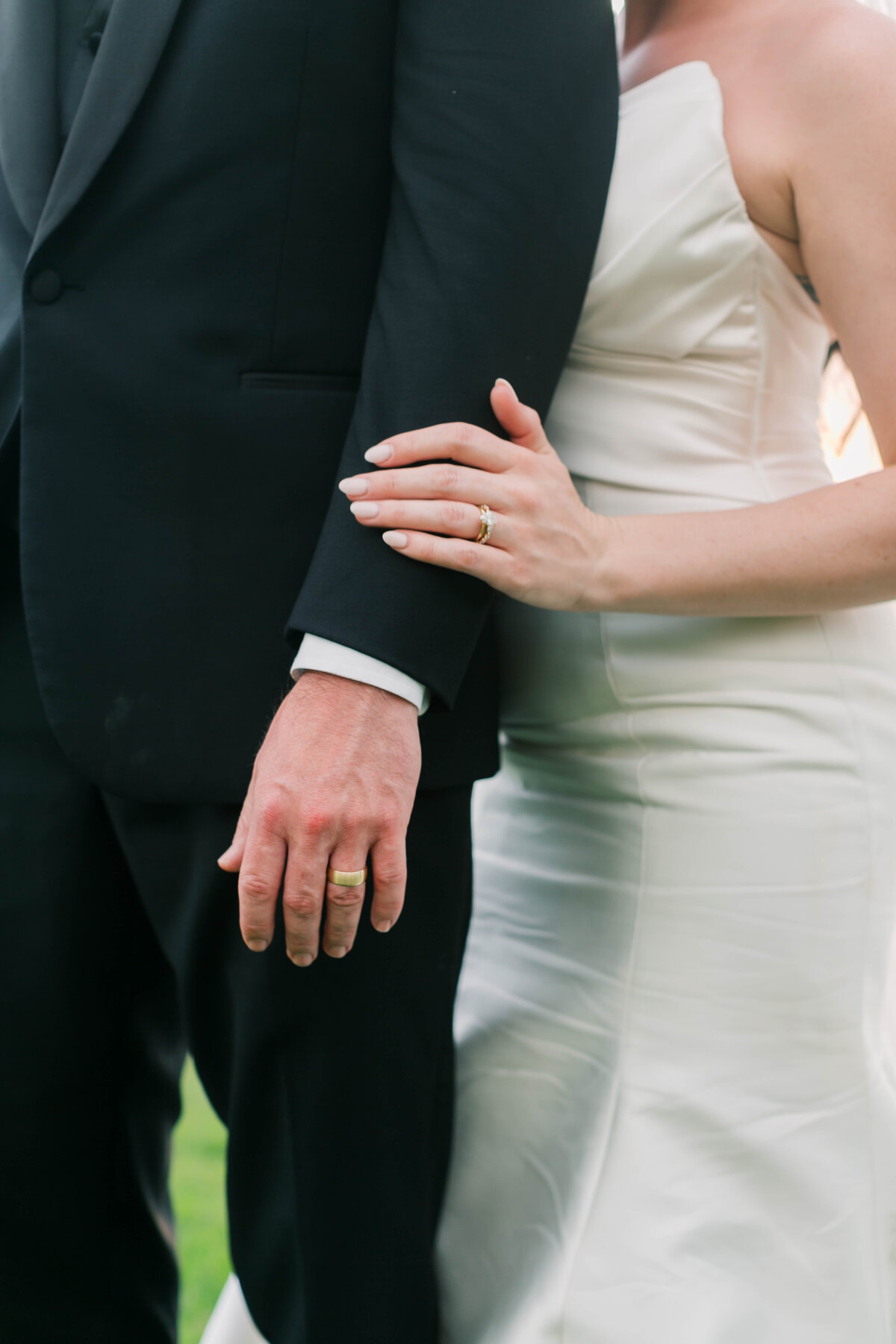 bride's hand on groom's arm