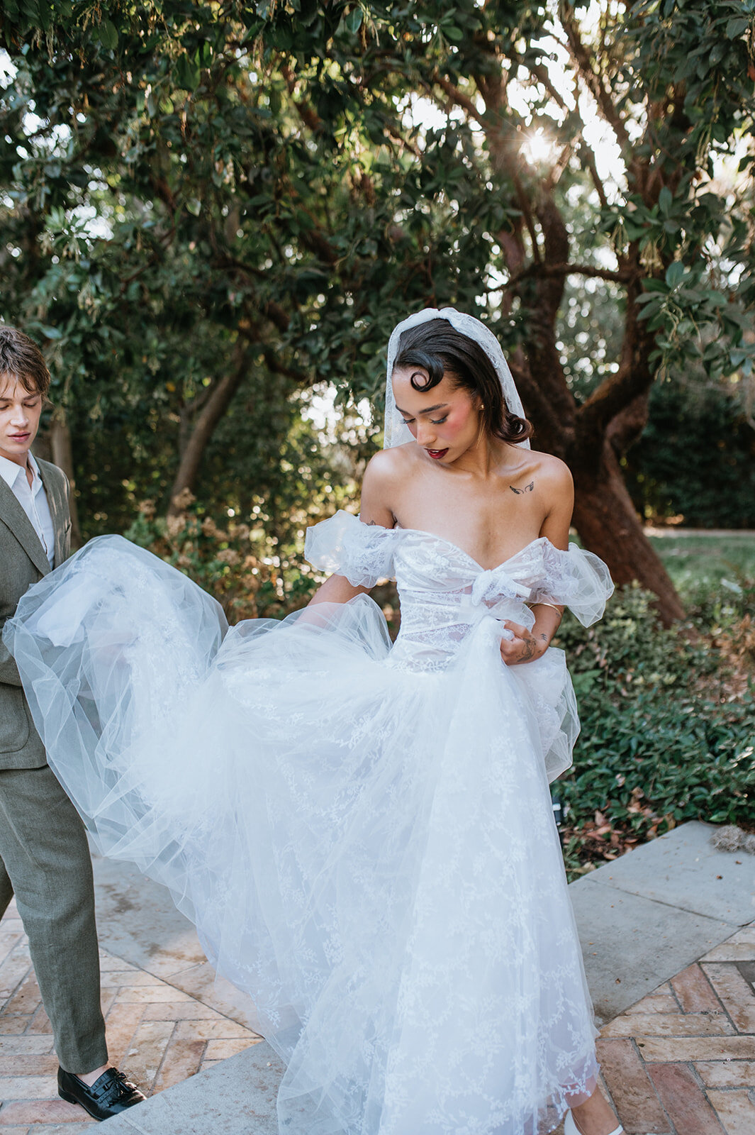 Groom-holding-brides-dress