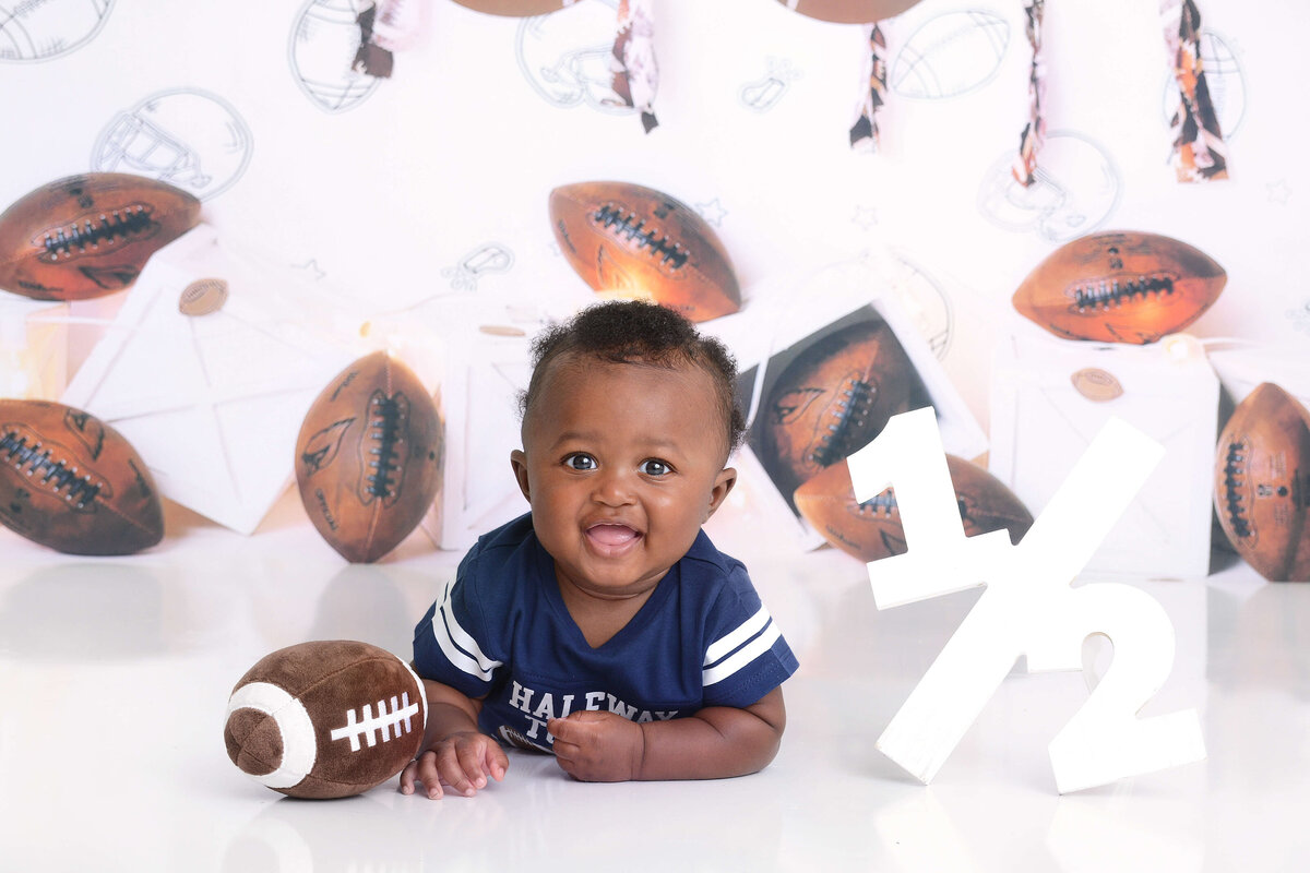 girl smiles at her girly first birthday photoshoot in houston