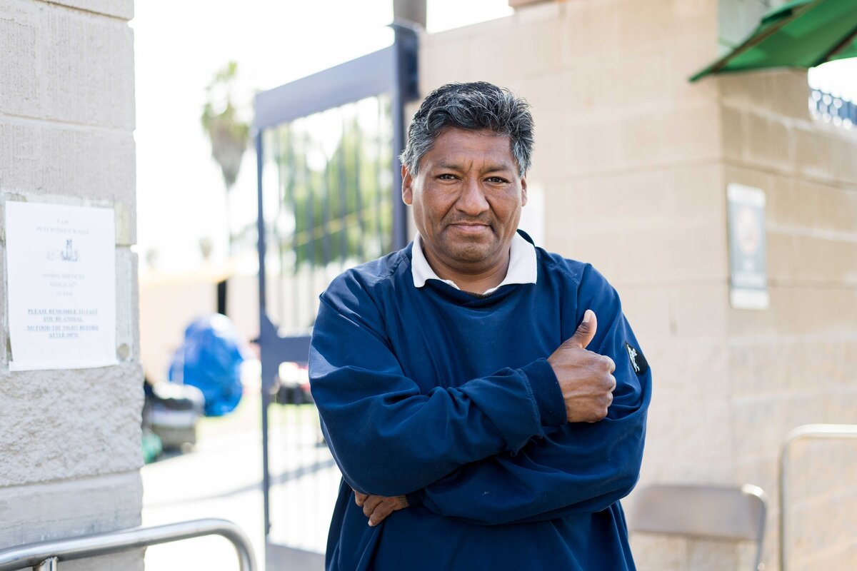 Man gives thumbs up outside Father Joes