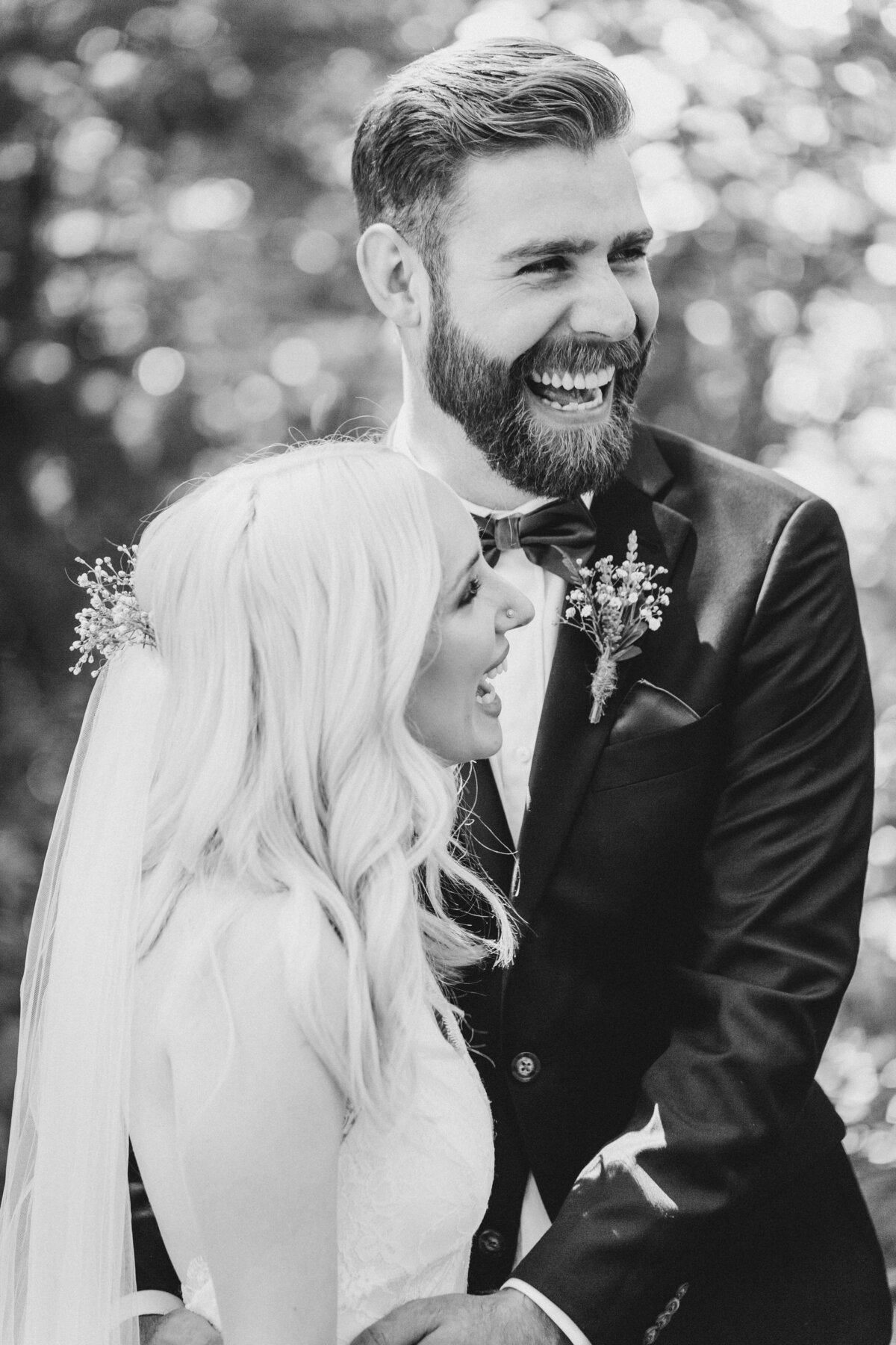 Utah Wedding Photography capturing black and white portrait of groom laughing