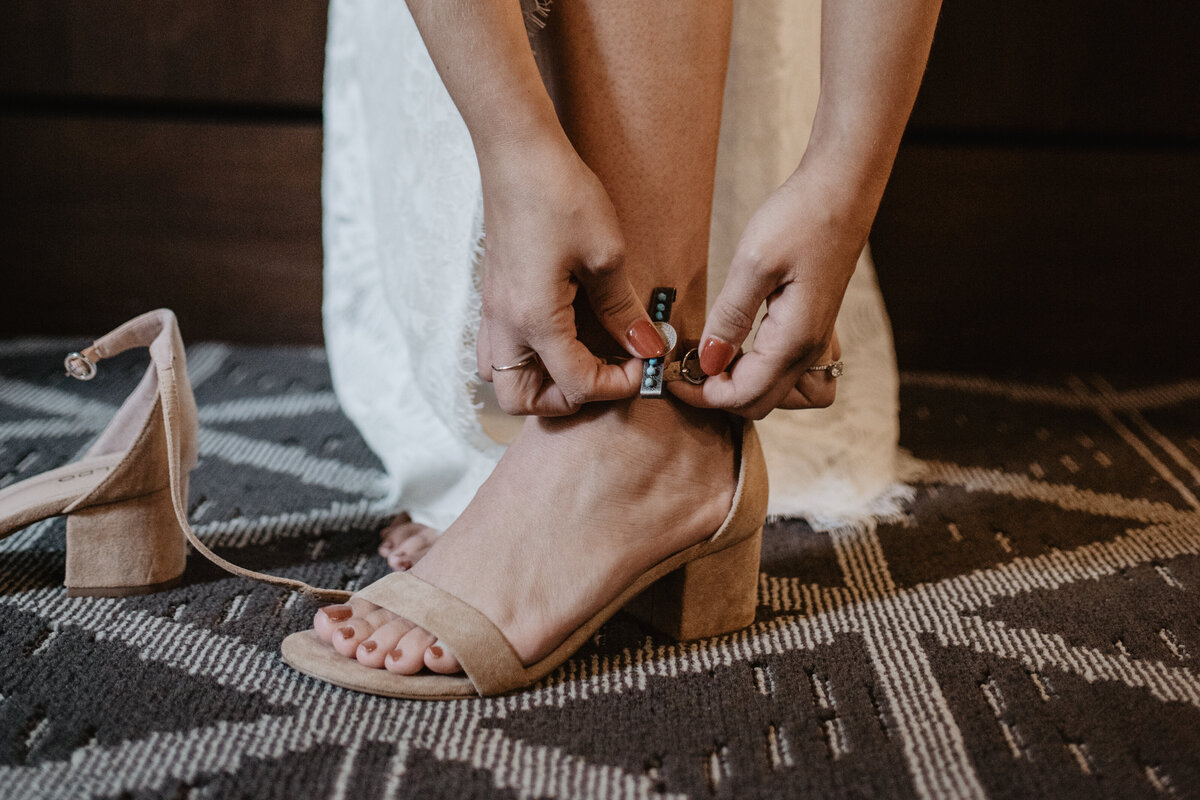 Photographers Jackson Hole capture bride putting on shoes before Grand Teton wedding