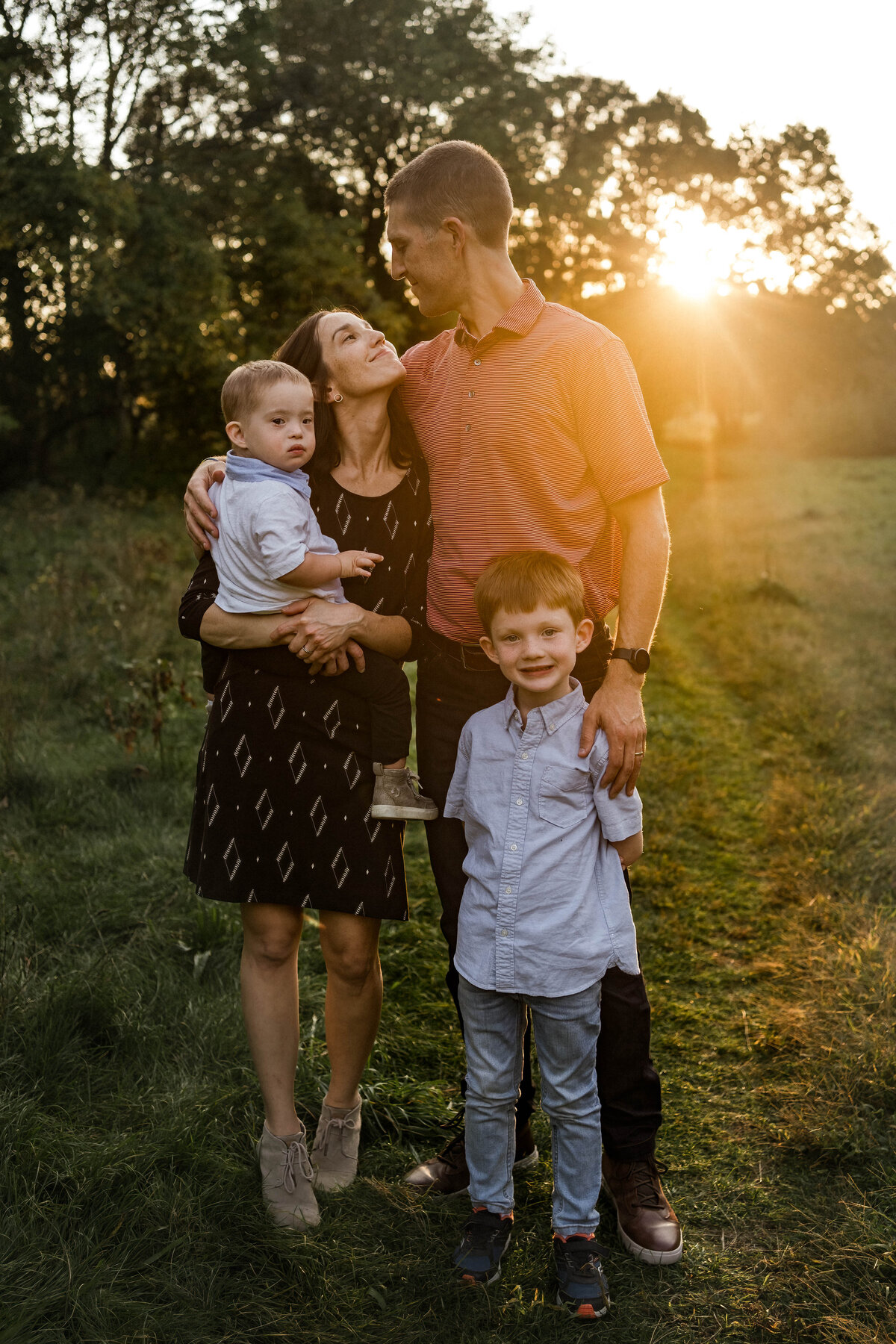 Family of 4 standing in Wayland field