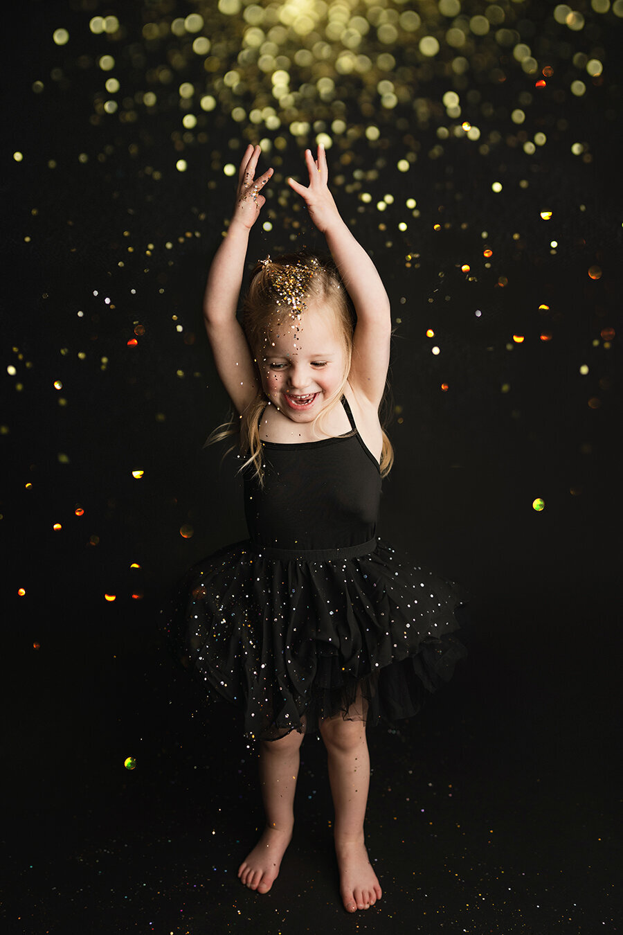 Adorable Fort Collins girl throwing glitter over her head